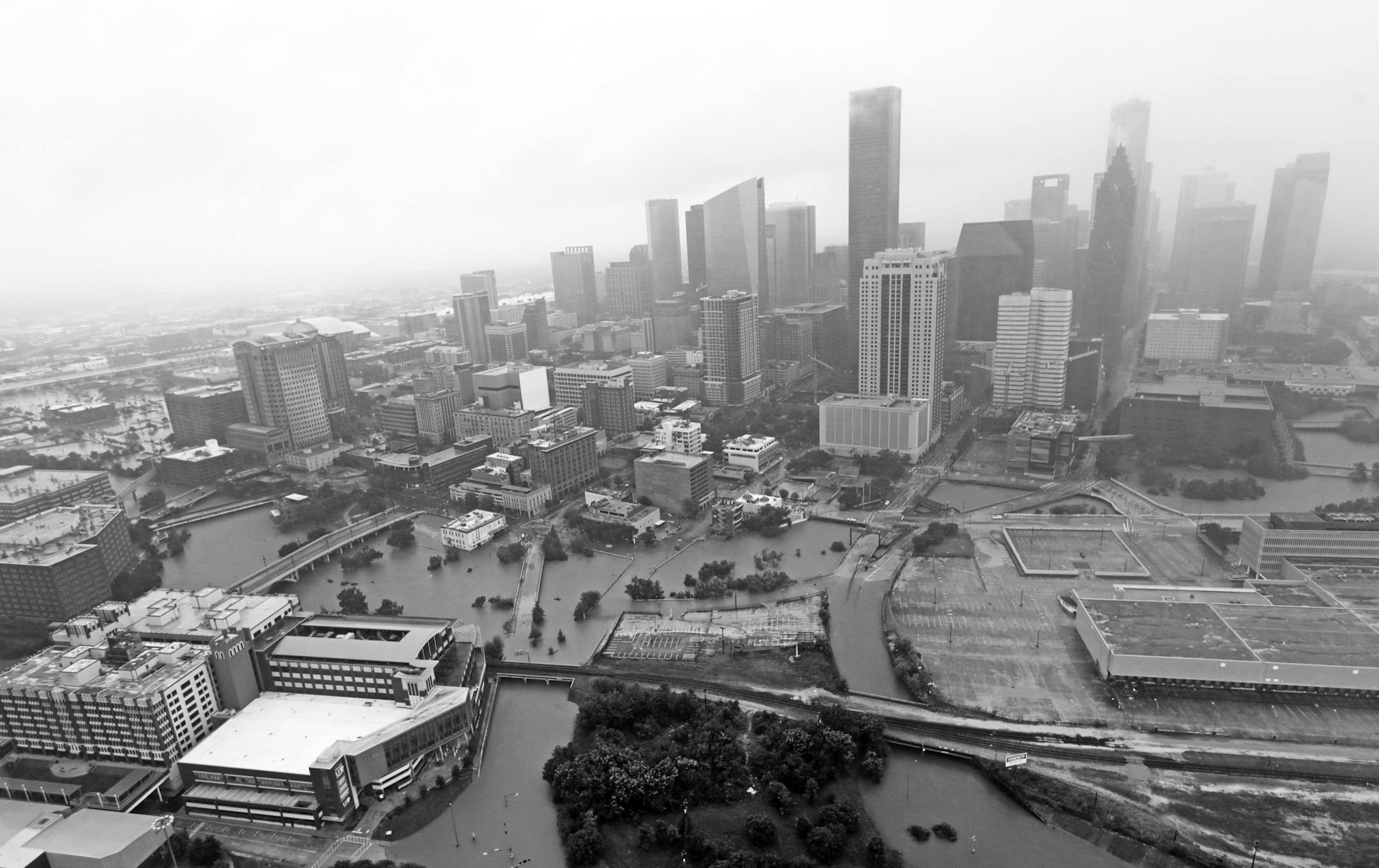 FILE- In this Tuesday, Aug. 29, 2017, file photo, highways around downtown Houston are empty as floodwaters from Tropical Storm Harvey overflow from the bayous around the city in Houston. The morgue in the fourth-largest city in the U.S. is near capacity, prompting officials to ask for a refrigerated tractor-trailer to handle any overflow. The bodies, storm-related and not, have accumulated over the past several days as Harveyís floodwaters swallowed the city, essentially closing down all b