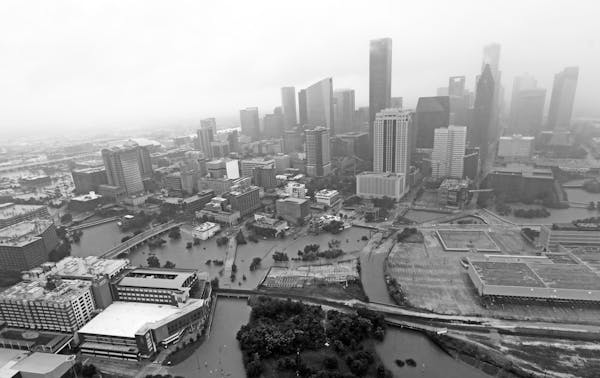 FILE- In this Tuesday, Aug. 29, 2017, file photo, highways around downtown Houston are empty as floodwaters from Tropical Storm Harvey overflow from t