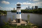 A lighthouse featuring the Park Board logo stands on Hall’s Island beside the Mississippi River. The agency recently restored the historical island,