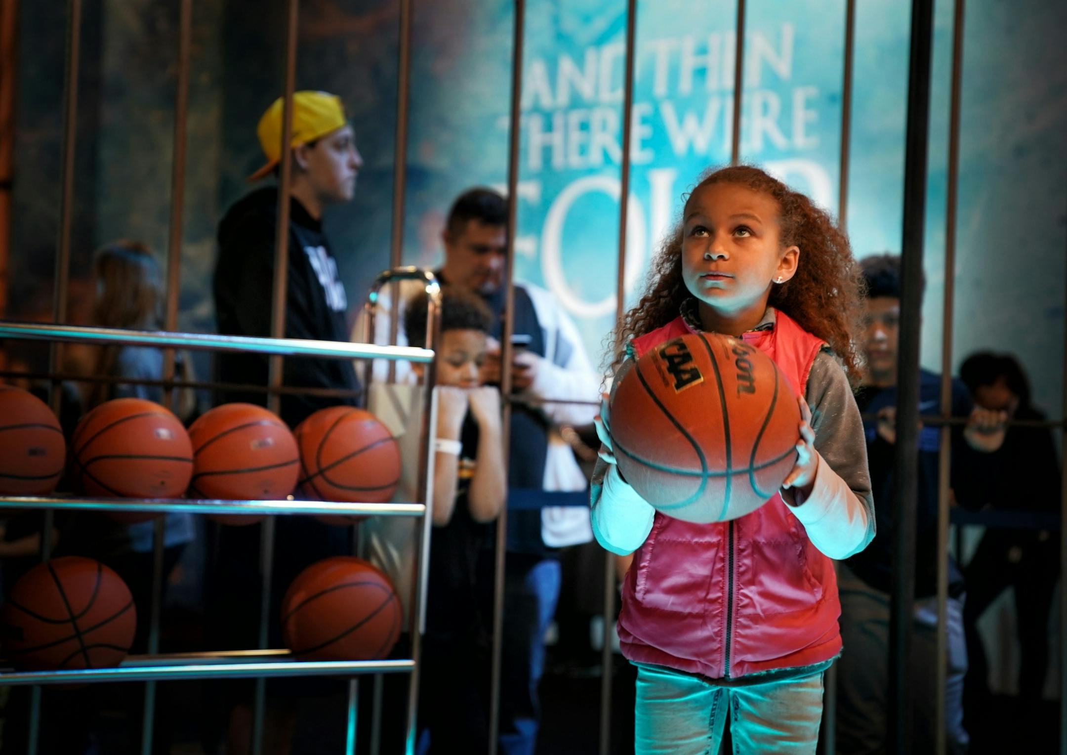 Whitney People, 9, focused on the hoop as she prepared for her shot at the Game of Thrones/AT&T court. Final Four Fan Fest at the Minneapolis Convention Center.