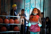 Whitney People, 9, focused on the hoop as she prepared for her shot at the Game of Thrones/AT&T court. Final Four Fan Fest at the Minneapolis Conventi