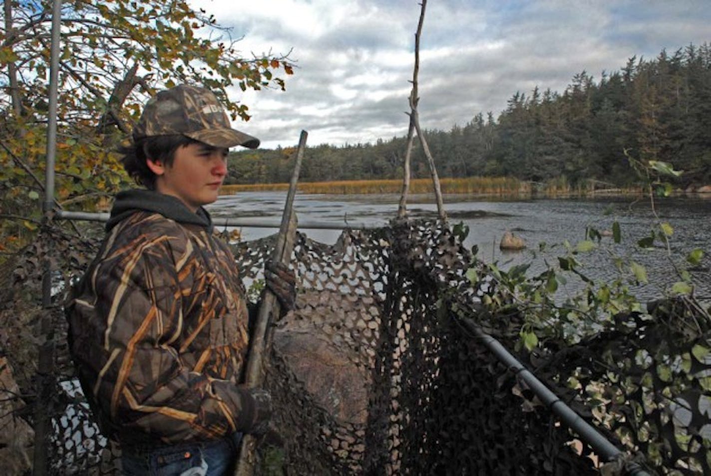 Parker Smith, a Willmar eighth-grader, overlooks a Minnesota River backwater in Renville County on the first day of duck hunting  Saturday. Hunting generally was good.