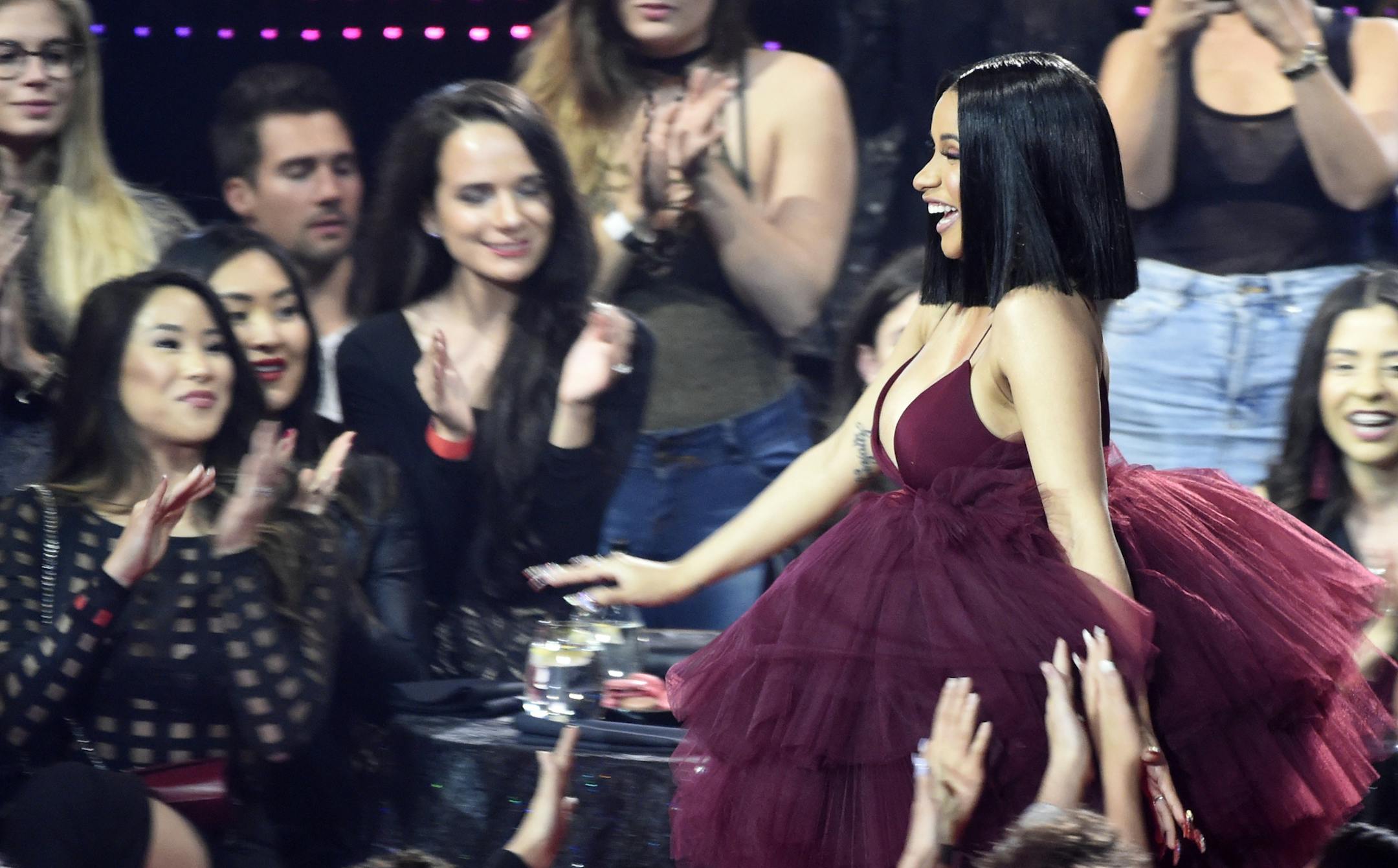 Singer Cardi B makes her way through the crowd after winning Best New Artist during the 2018 iHeartRadio Music Awards at The Forum on Sunday, March 11, 2018, in Inglewood, Calif. (Photo by Chris Pizzello/Invision/AP) ORG XMIT: CACP129