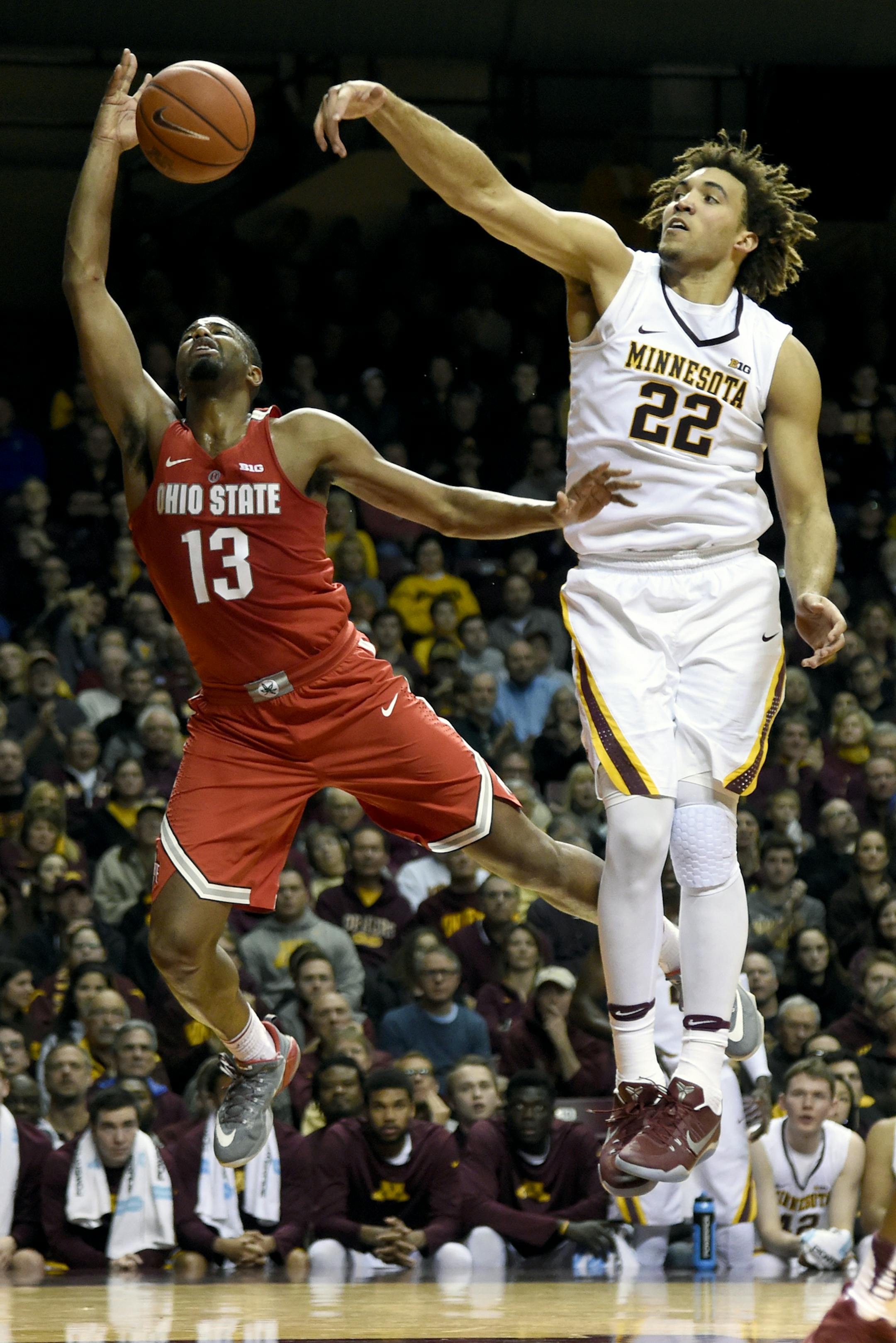Minnesota center Reggie Lynch (22) blocks a shot by Ohio State guard JaQuan Lyle (13) during the first half of an NCAA college basketball game Sunday, Jan. 8, 2017, in Minneapolis. Minnesota won 78-68. (AP Photo/Hannah Foslien)