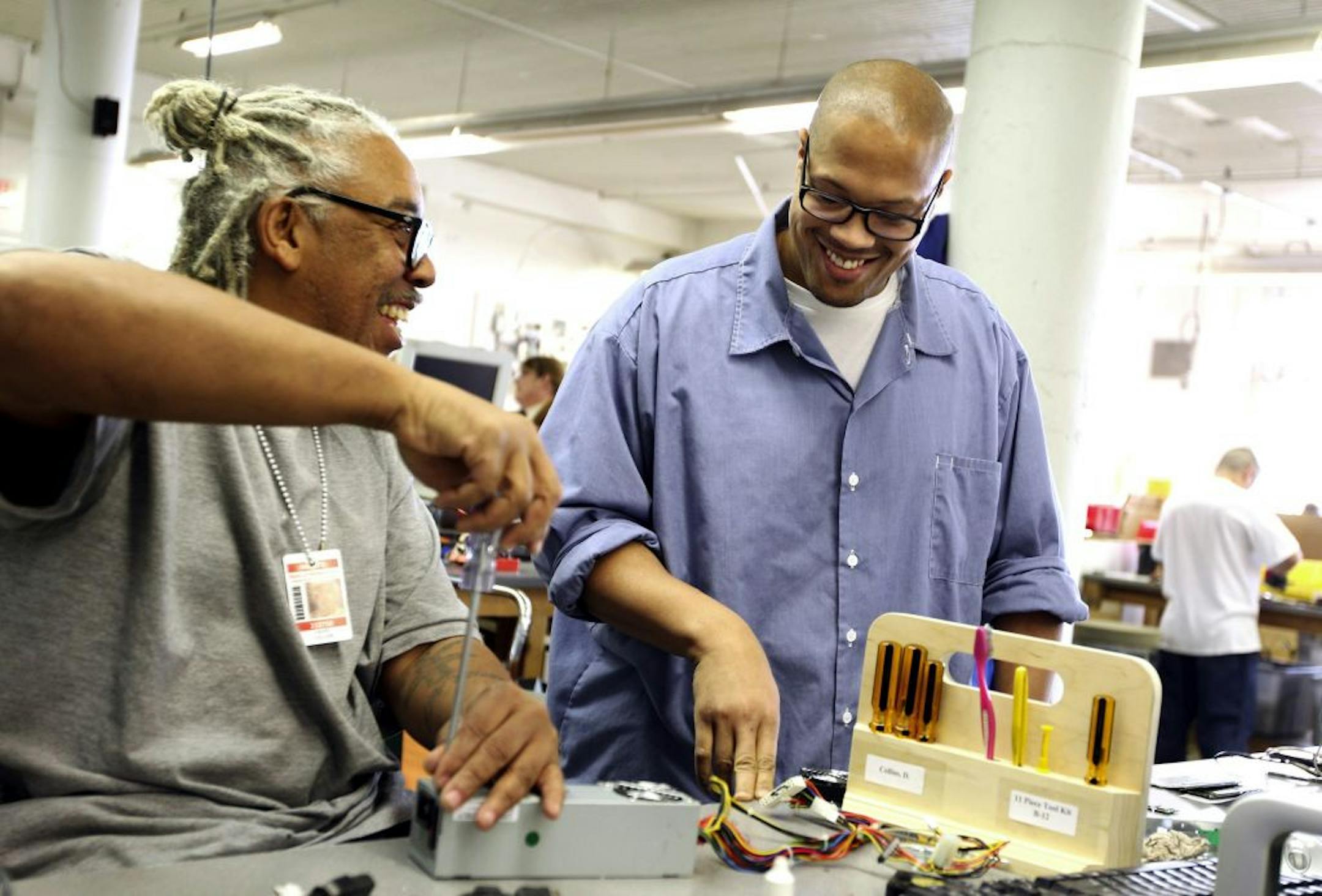 Prison inmates Carlos Smith, right, and David Collins refurbish computers for the Minnesota Computers for Schools program at the Minnesota Correctional Facility-Stillwater in Bayport November 16, 2011. Last year over 3,400 donated computers were refurbished instead of being destroyed.