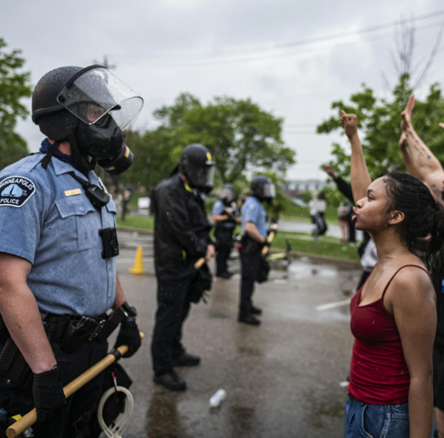 Protesters and police face each other during a rally against the death of George Floyd in Minneapolis on Tuesday, May 26, 2020. Four Minneapolis officers involved in the arrest of the black man who died in police custody were fired Tuesday, hours after a bystander's video showed an officer kneeling on the handcuffed man's neck, even after he pleaded that he could not breathe and stopped moving. (Richard Tsong-Taatarii/Star Tribune via AP)