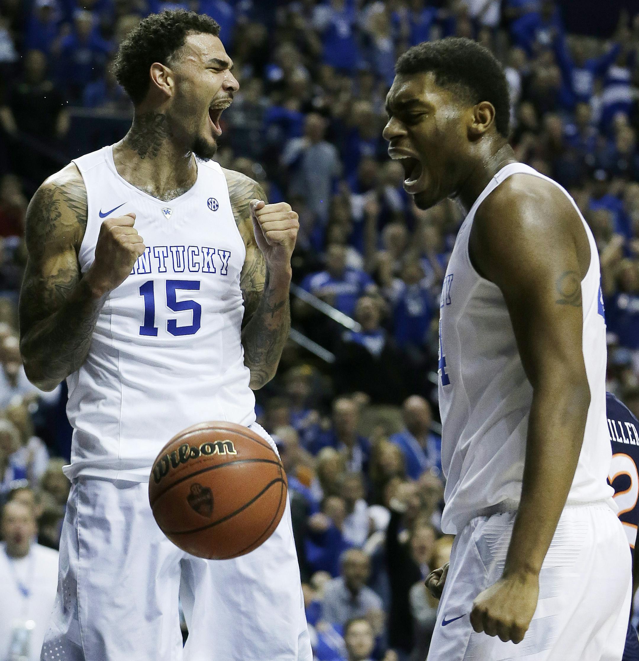 Kentucky forward Willie Cauley-Stein (15) celebrates his dunk with Kentucky center Dakari Johnson (44) against Auburn during the first half of an NCAA college basketball game in the semifinal round of the Southeastern Conference tournament, Saturday, March 14, 2015, in Nashville, Tenn. (AP Photo/Mark Humphrey)