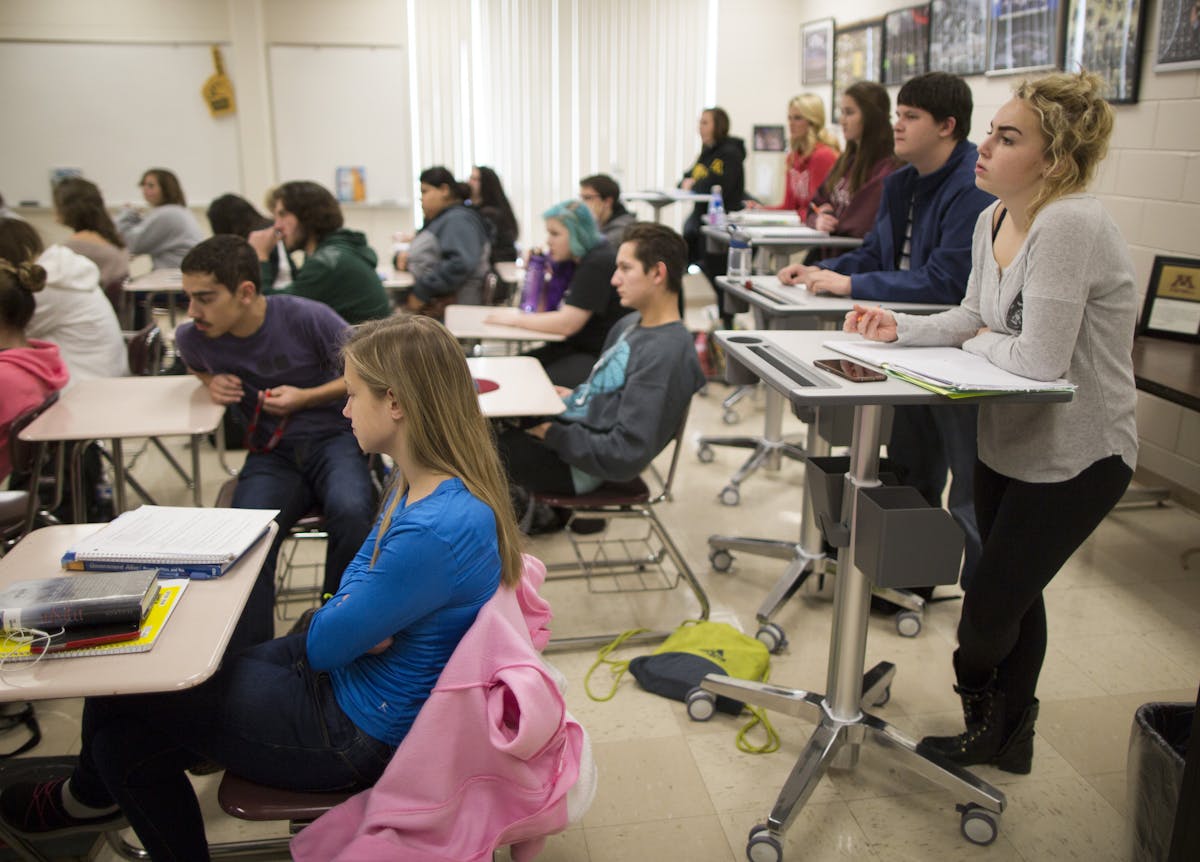 Students across the state are ditching seats for taller standing desks, which advocates are saying will boost test scores and burn calories. Here, Cas