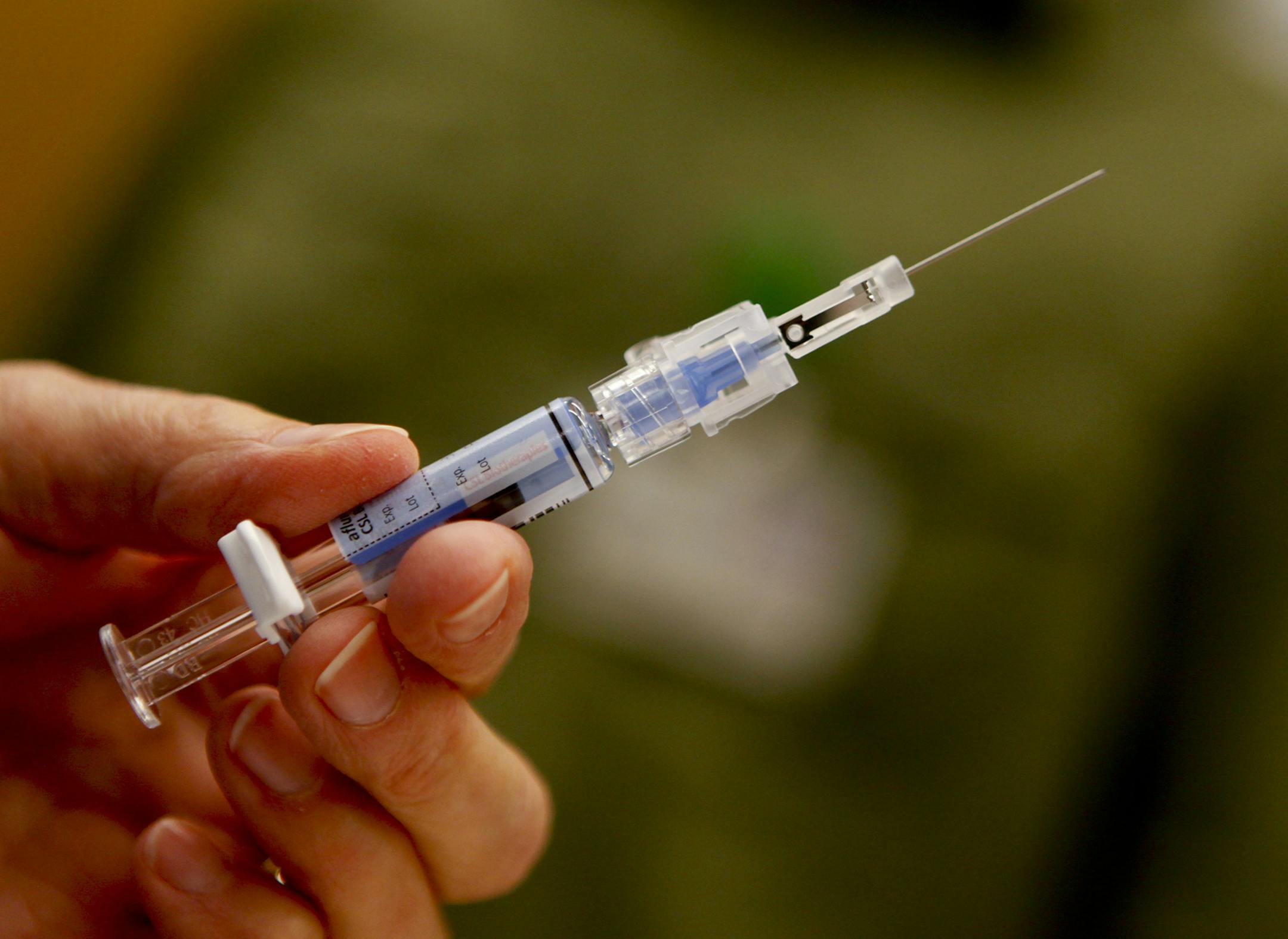 Downey Regional Medical Center RN Connie Meinke holds a syringe filled with the flu vaccine before injecting a fellow employee on January 17, 2013. Like many hospitals across the U.S., the Downey, California, facility is preparing for the flu onslaught. The hospital is asking all of their employees to be vaccinated. (Mark Boster/Los Angeles Times/MCT) ORG XMIT: 1133860