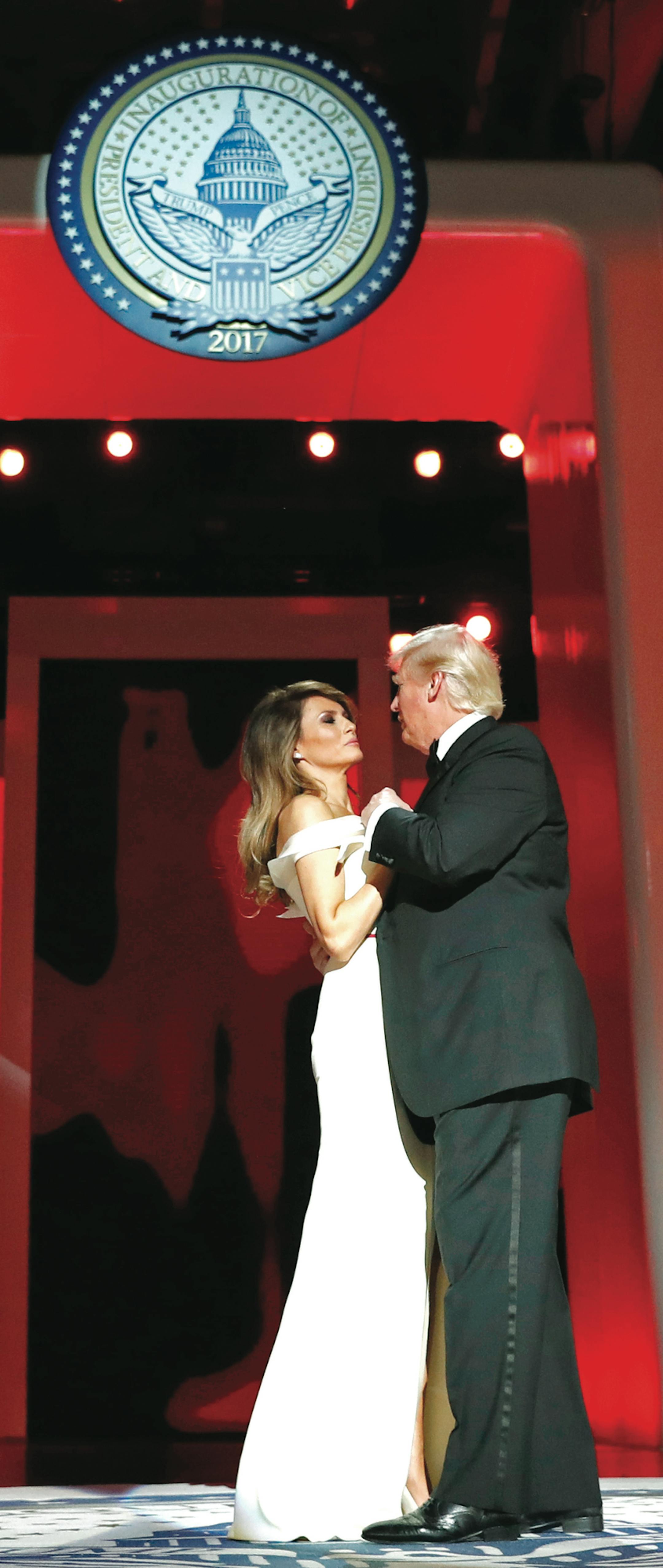 President Donald Trump dances with first lady Melania Trump as Vice President Mike Pence dances with his wife Karen at the Liberty Ball, Friday, Jan. 20, 2017, in Washington. (AP Photo/Alex Brandon)
