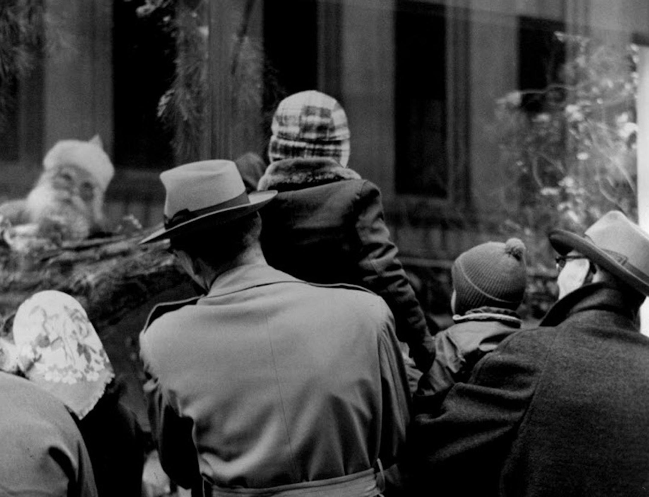 In 1955 Minneapolis, parents held their children up to see Santa in the downtown Dayton's window.