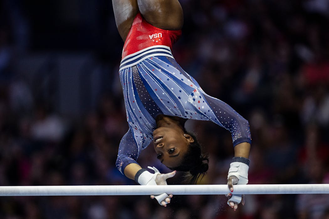 Simone Biles competes on uneven bars during the U.S. Gymnastics Olympic Trials at Target Center on Friday.  