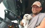Nebraska trucker Chris Peters with his pup Oscar at Stockman's Truck Stop in South St. Paul.