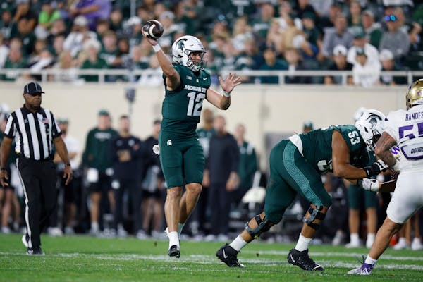 Michigan State quarterback Katin Houser, left, made a throw in the Spartans’ 41-7 loss to Washington on Sept. 16.