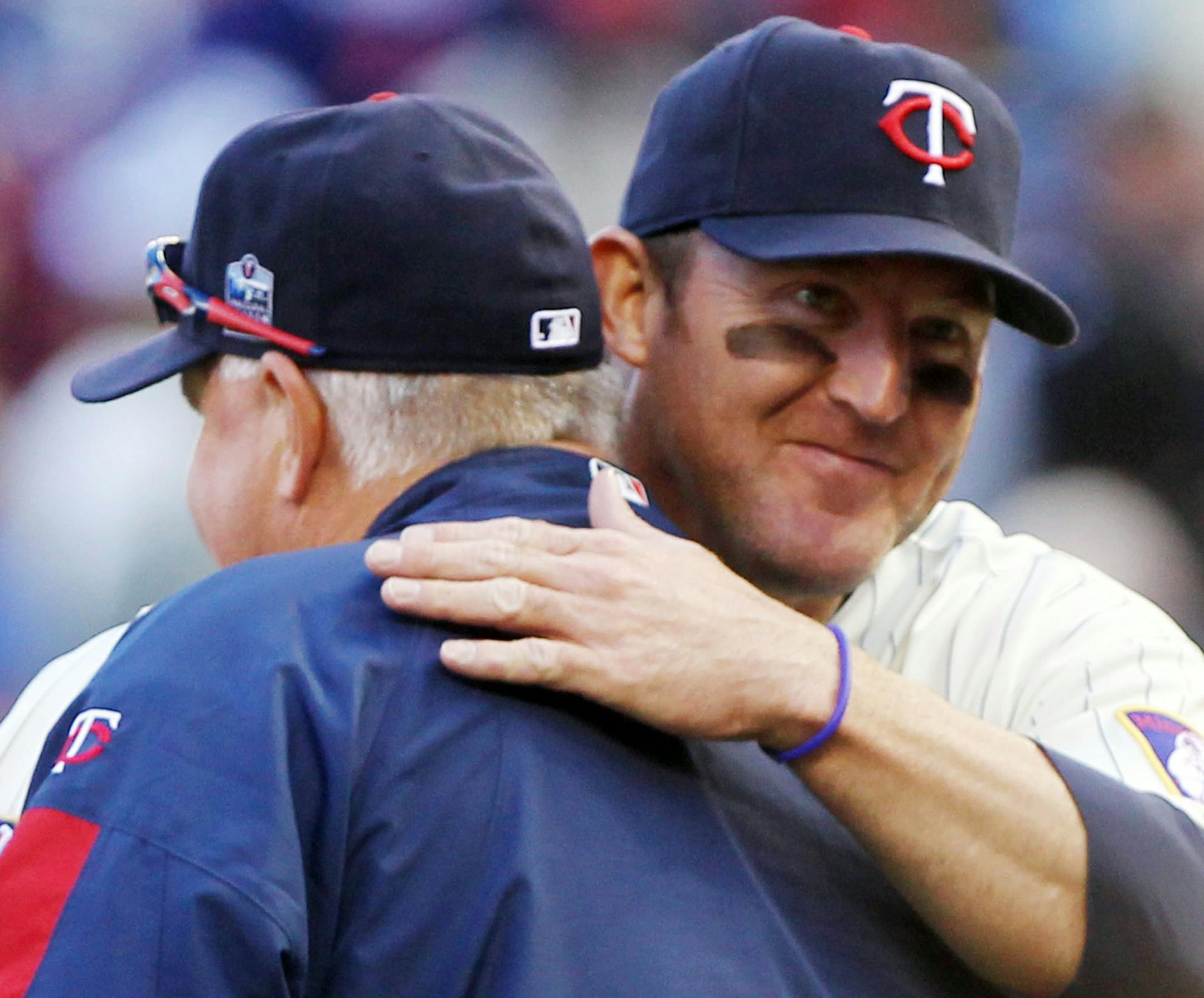 DAVID JOLES • djoles@startribune.com - Minneapolis, MN - Sept 4, 2010- Texas Rangers versus the Minnesota Twins at Target Field. In this photo] The Twins Jim Thome gets a hug from manager Ron Gardenhire following the Twins 12-4 win over Texas.