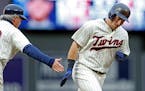 Minnesota Twins' Robbie Grossman rounds third base on a two-run home run off Kansas City Royals pitcher Ian Kennedy in the first inning during the sec