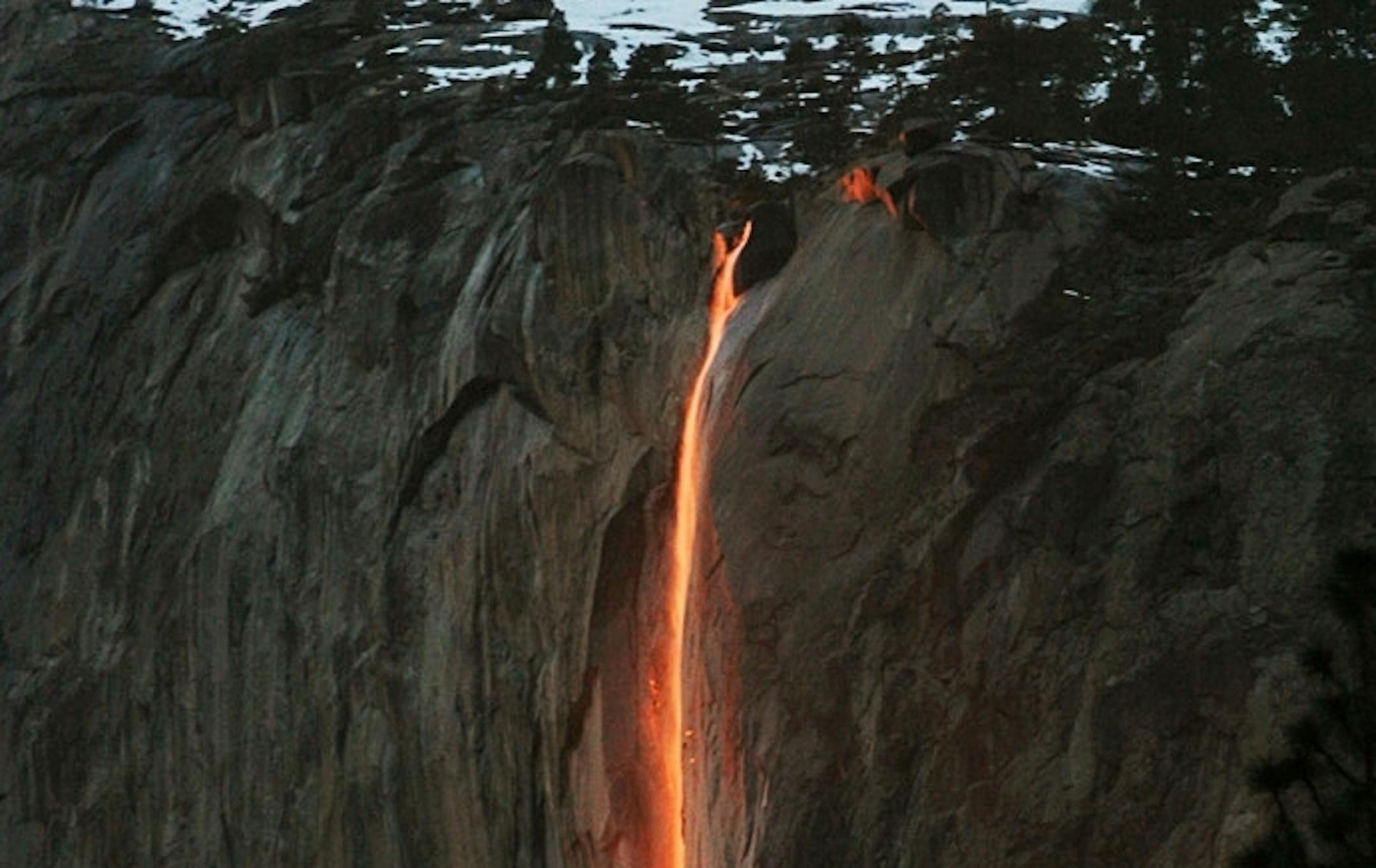 In this Feb. 16, 2010, file photo, a shaft of sunlight creates a glow near Horsetail Fall, in Yosemite National Park, Calif.