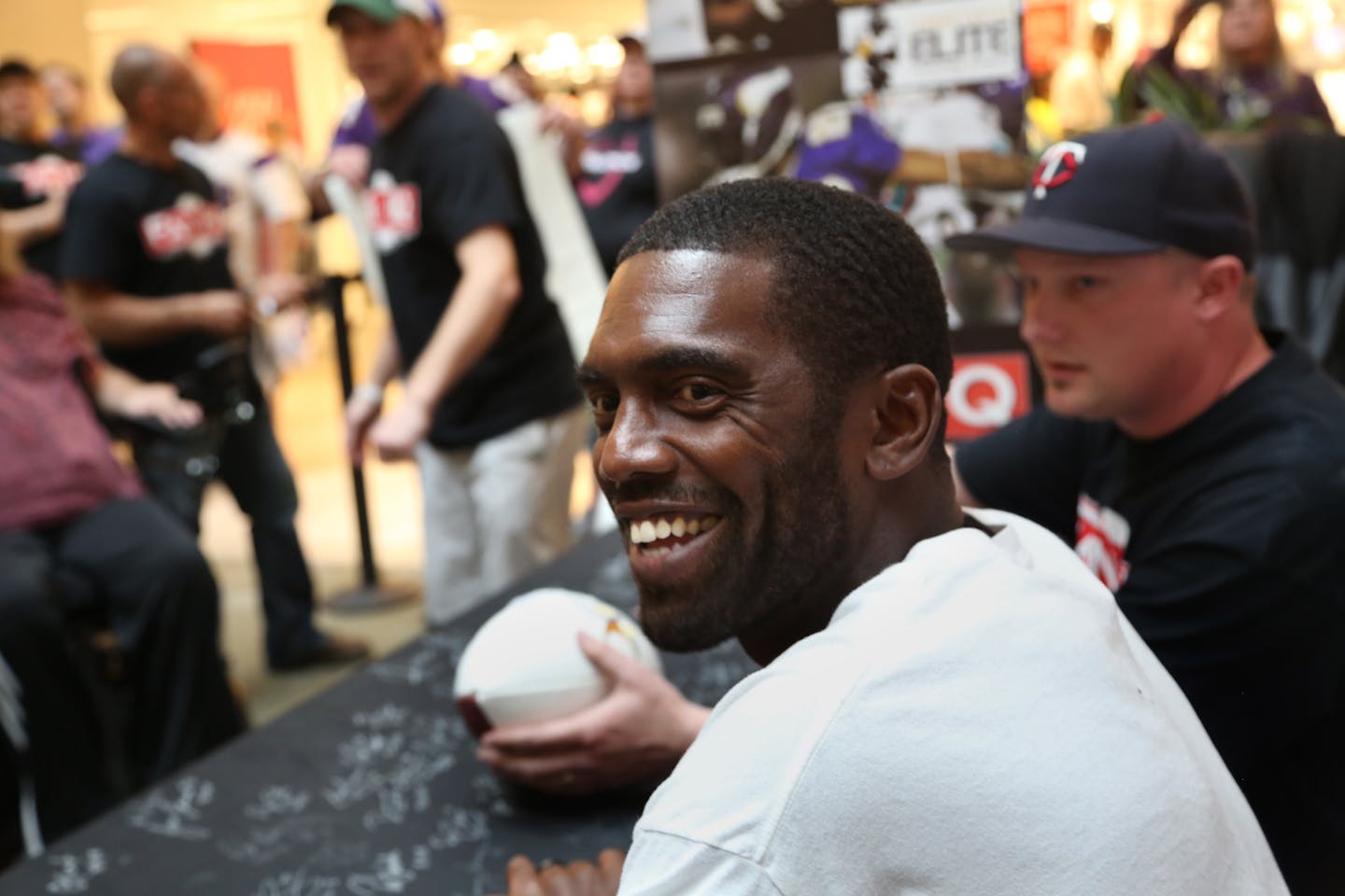 Former Viking Randy Moss smiled at fans as he passed from signing autographs. ] (KYNDELL HARKNESS/STAR TRIBUNE) kyndell.harkness@startribune.com Former Minnesota Viking Randy Moss and Tyrone Cater signed autographs at the Ridgedale Mall in Minnetonka Min., Saturday, May 23, 2015. Ticket purchases benefit Tyrone Carter�s TC Elite Training School and will allow financially challenged Minnesota athletes the opportunity to attend Carter�s intensive football camps.