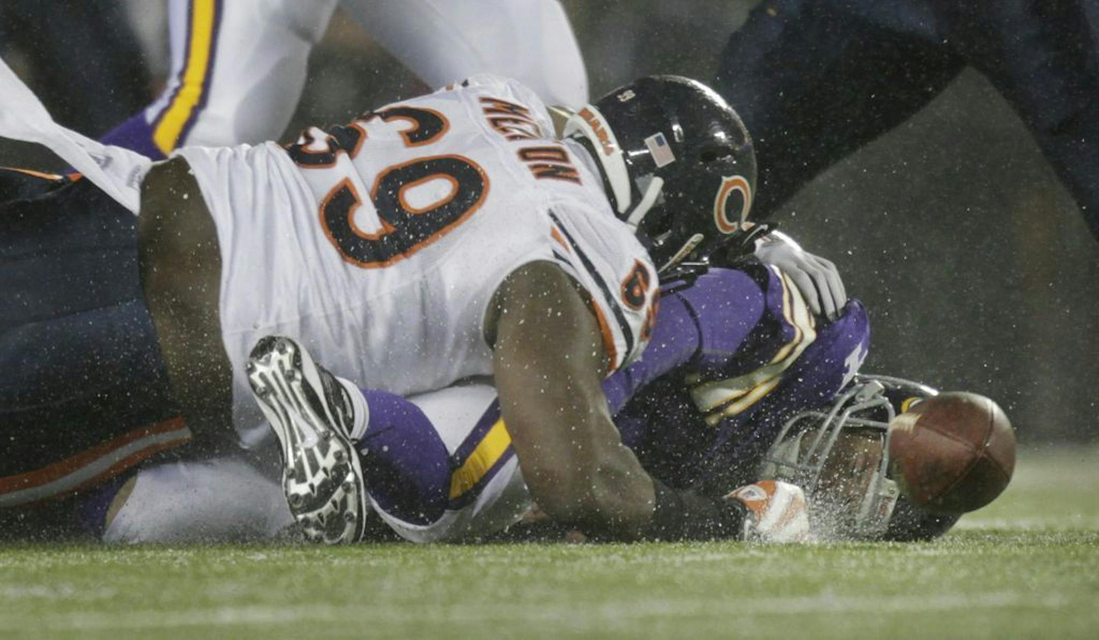 Vikings versus Chicago Bears at TCF Bank Stadium. In this photo: Bears Henry Melton lands on Brett Favre after he was sacked by Corey Wootton. Favre left the game with a head injury.