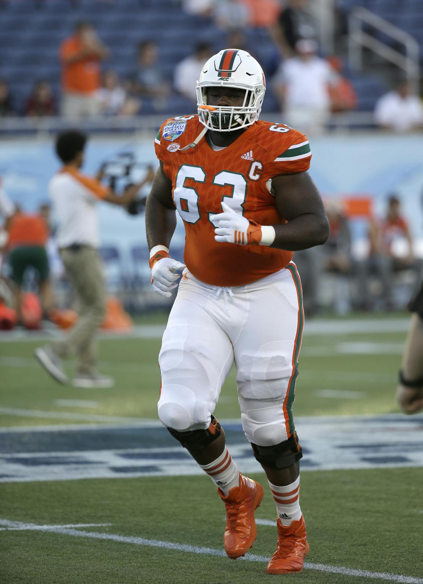 Miami offensive lineman Danny Isidora (63) warms up before the first half of the Russell Athletic Bowl NCAA college football game against West Virginia, Wednesday, Dec. 28, 2016, in Orlando, Fla. (AP Photo/John Raoux) ORG XMIT: FLJR1