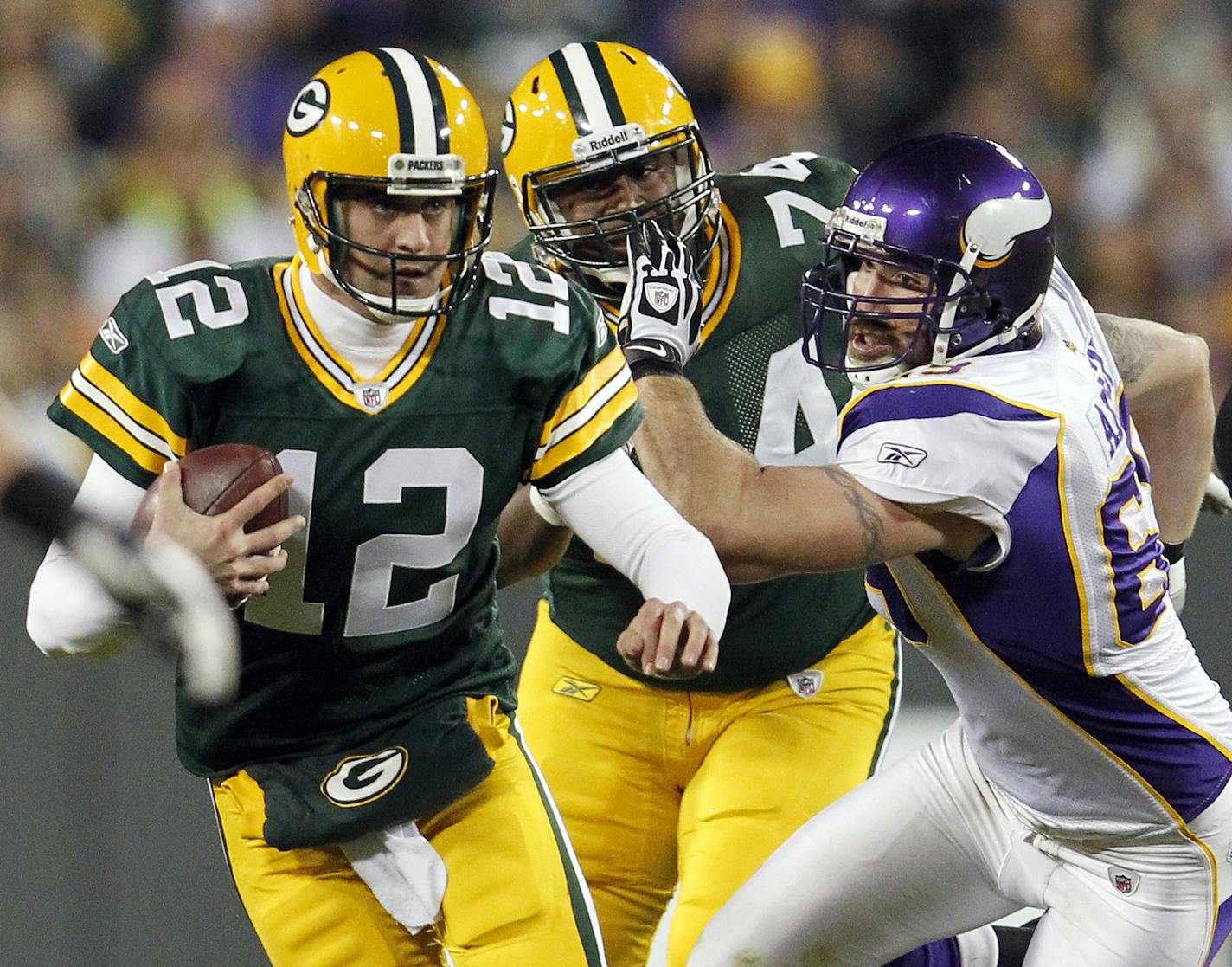 Aaron Rodgers (12) scrambled away from Jared Allen (69) in the second quarter. ] CARLOS GONZALEZ cgonzalez@startribune.com, November 14, 2011, Green Bay, WI, NFL, Lambeau Field, Minnesota Vikings vs. Green bay Packers ORG XMIT: MIN2012091411434555