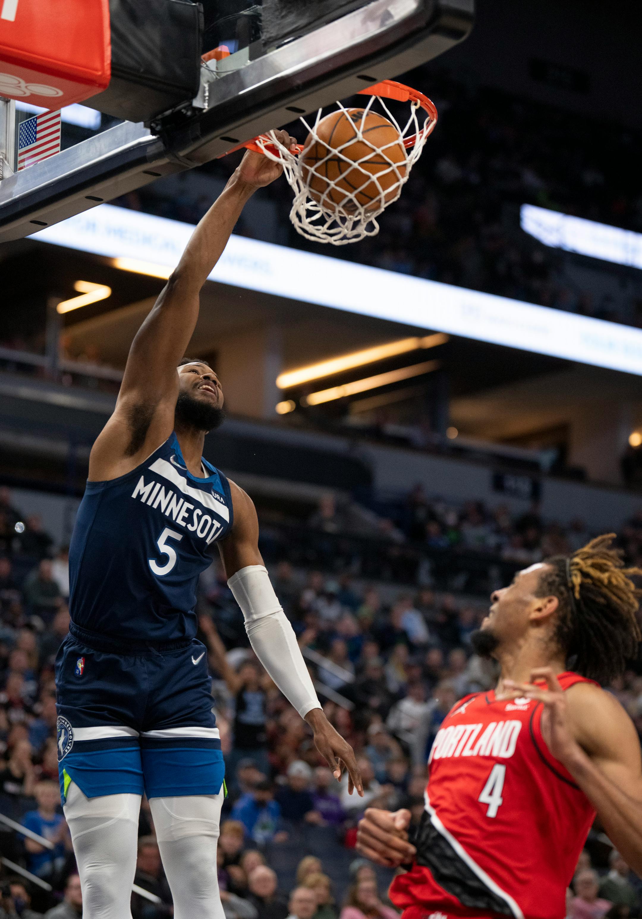 Minnesota Timberwolves guard Malik Beasley (5) dunked over Portland Trail Blazers forward Greg Brown III (4) in the first quarter.