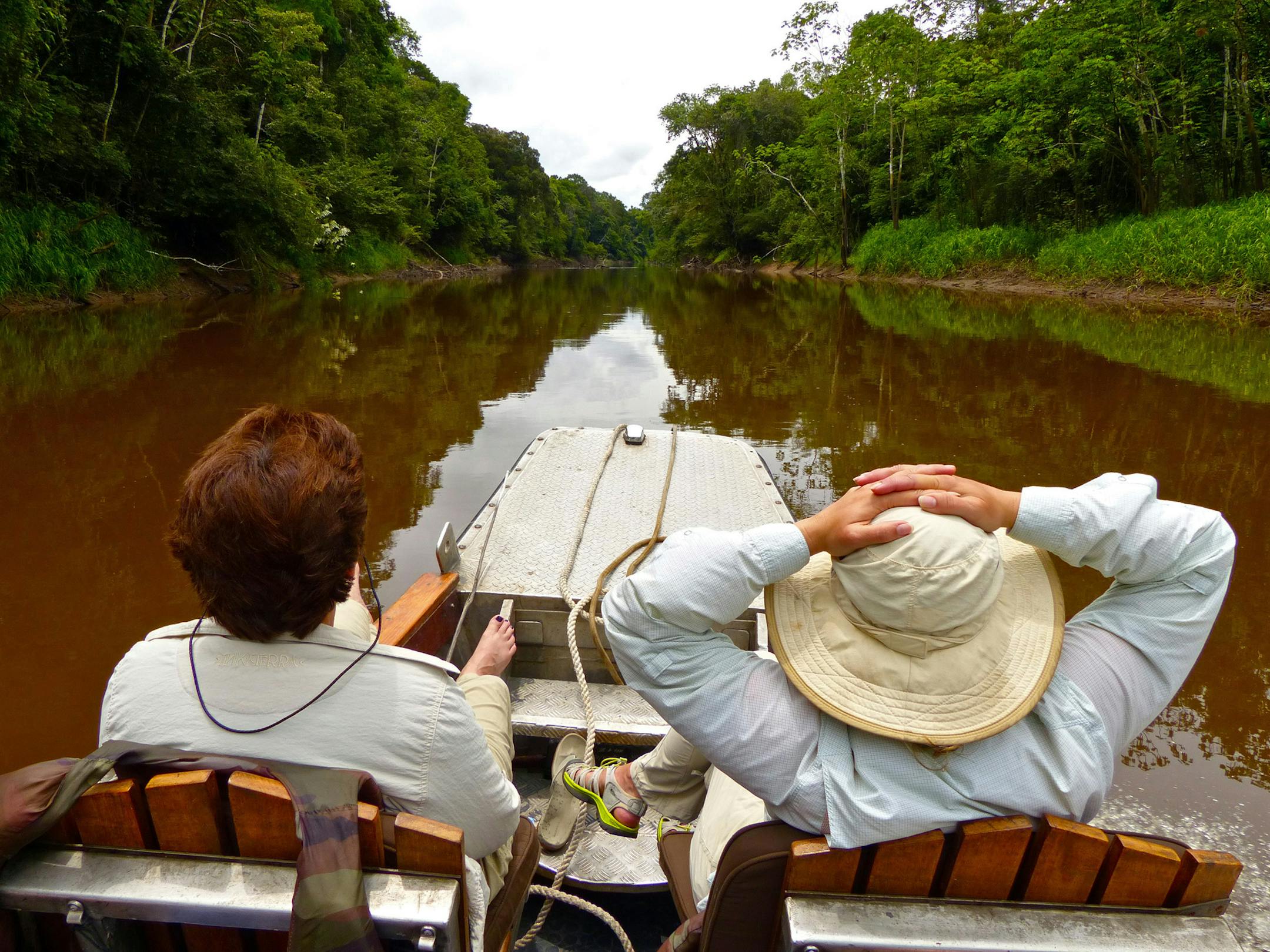 The author (right) and a friend take in the sights of a smaller tributary of the Amazon river in Peru’s Pacaya Samiria National Reserve.