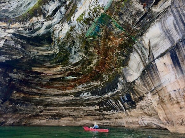 This file photo from Aug. 1, 2018 shows the scale of the cliffs along Pictured Rocks National Lakeshore in Michigan, along the south shore of Lake Sup