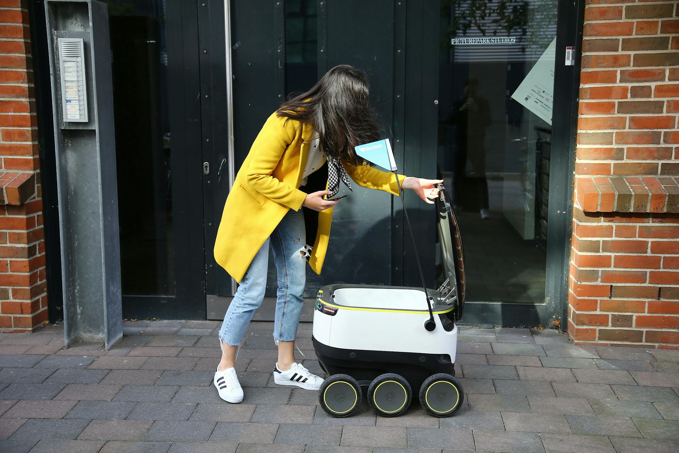 A self-driving delivery robot developed by Starship Technologies delivers a package on Oct. 5, 2016 in Hamburg, Germany. The robots are arriving on sidewalks in two U.S. cities this month. (Action Press/Zuma Press/TNS) ORG XMIT: 1194413