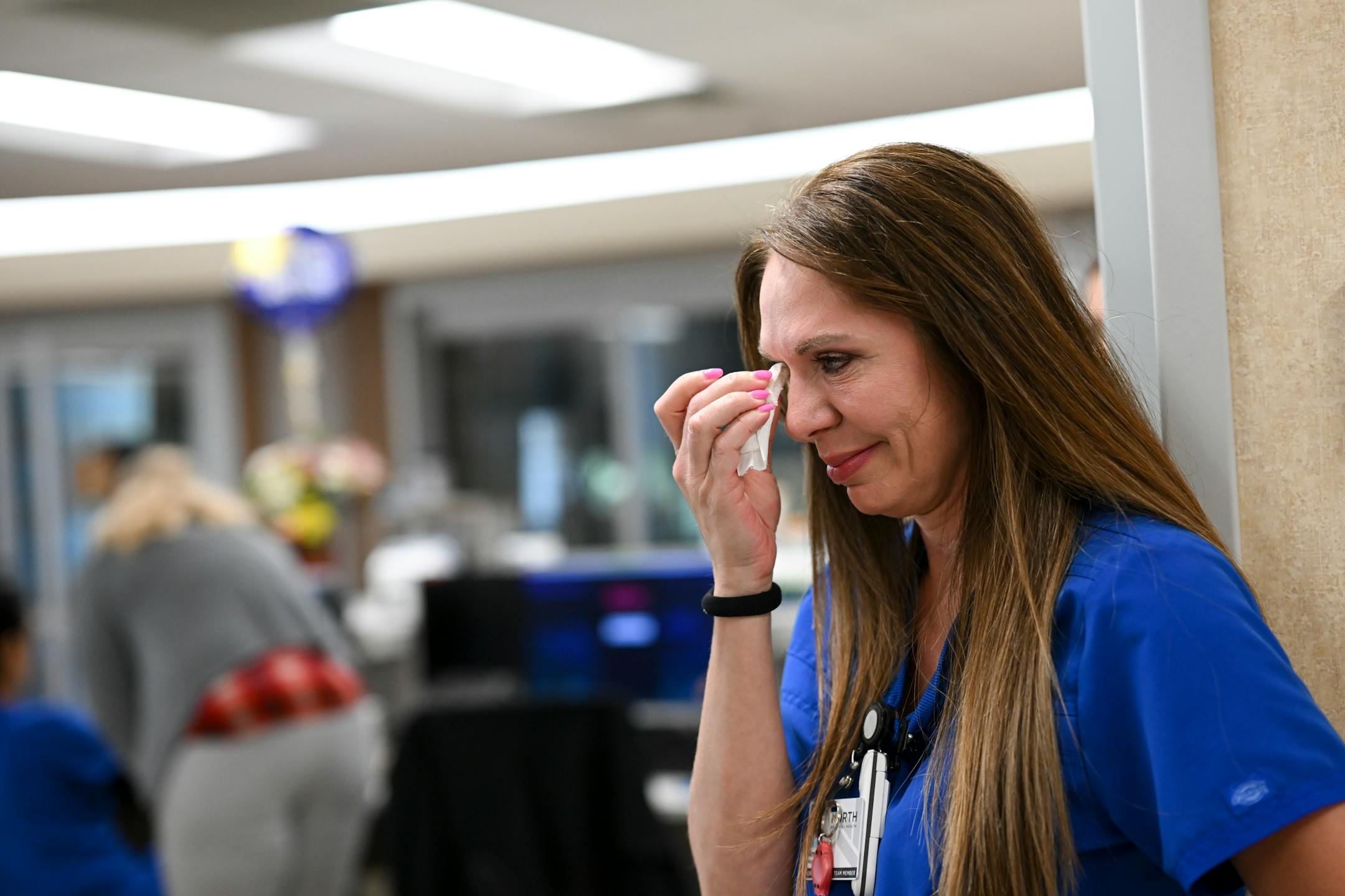 Critical Care nurse Amy Berwald wipes away tears after reuniting with COVID survivor Rick Ulrich Thursday, May 11, 2023, at North Memorial Health Hospital's South Seven Intensive Care Unit in Robbinsdale, Minn.