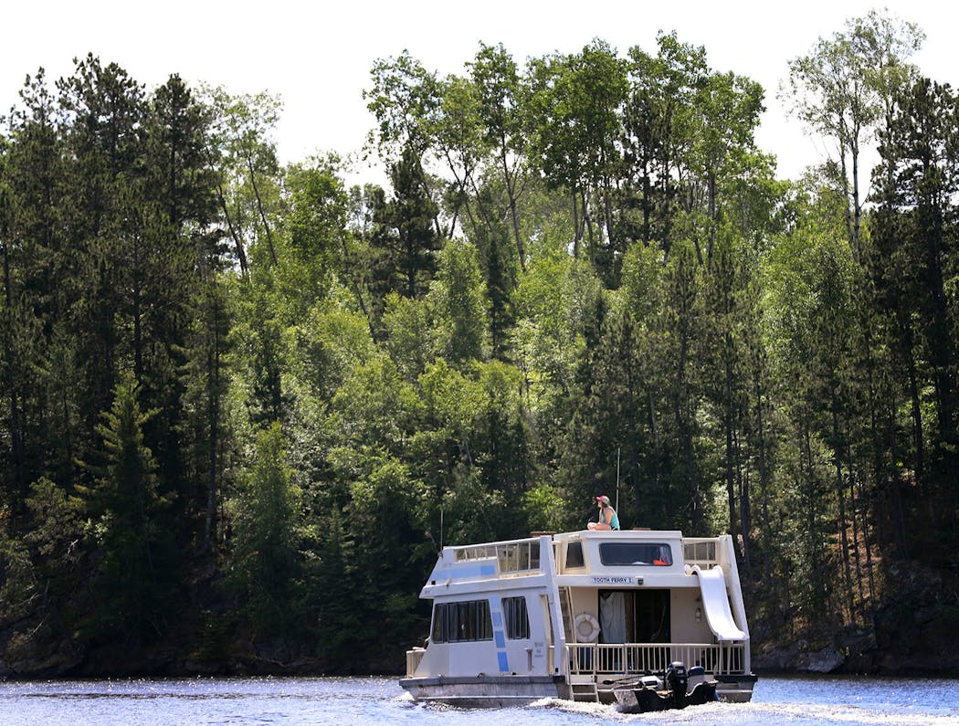 A houseboat plies the waters of Namakan Lake in Voyageurs National Park