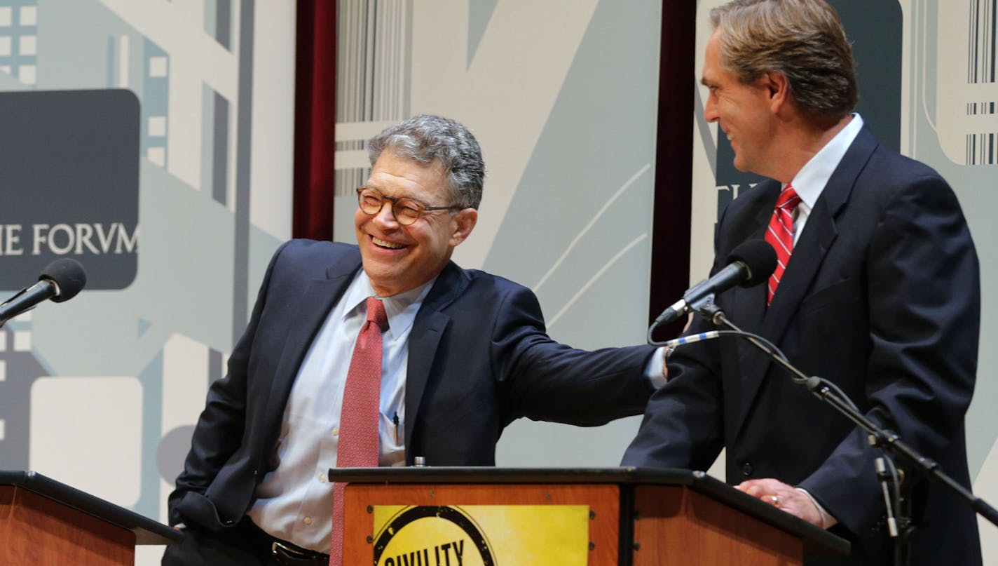 Democratic U.S. Sen. Al Franken, left, and Republican challenger Mike McFadden enjoy a laugh before their debate, Wednesday, Oct. 1, 2014, in Duluth, Minn.