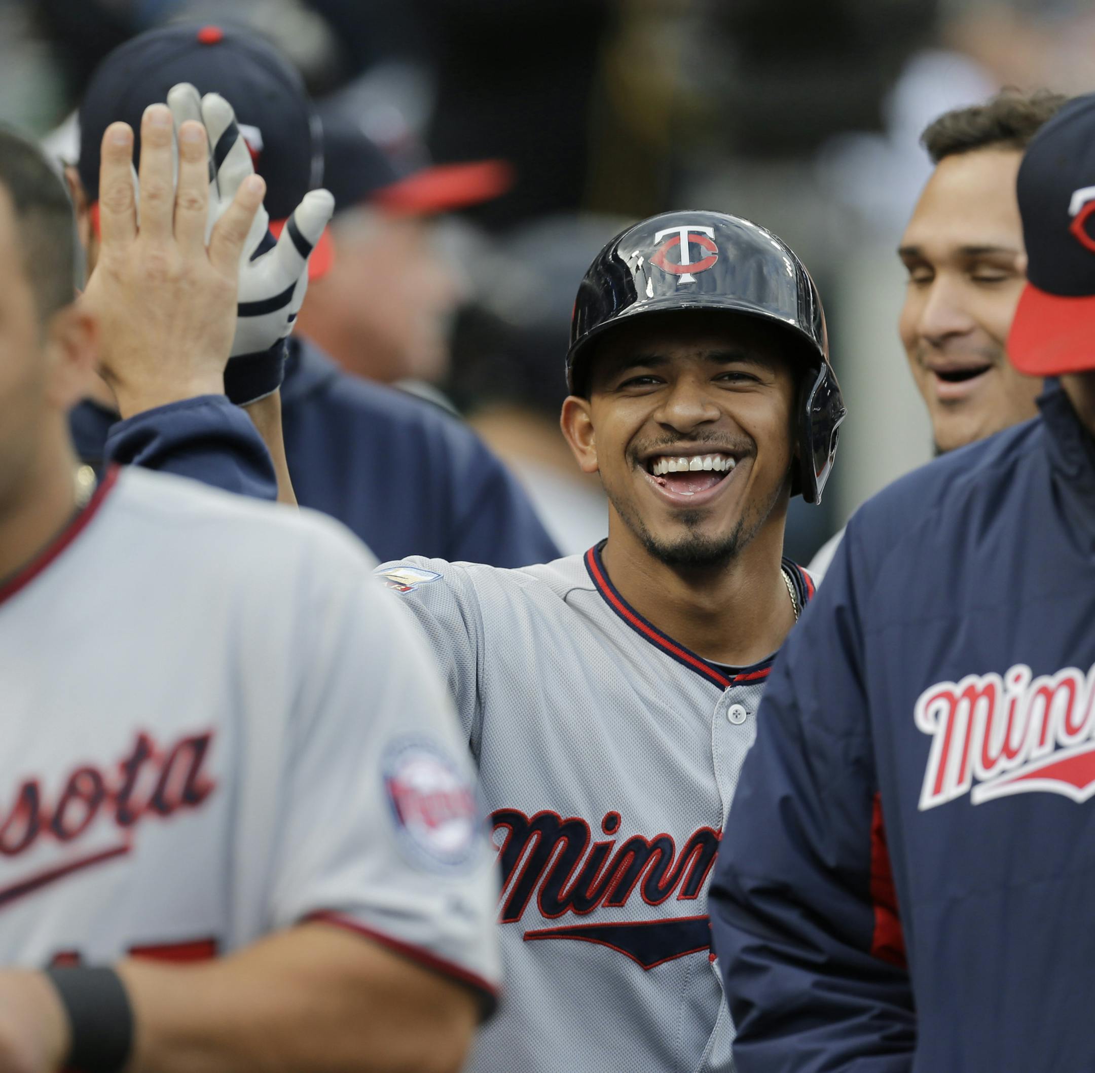 Minnesota Twins' Eduardo Escobar celebrates his solo home run against the Detroit Tigers in the third inning of a baseball game in Detroit, Friday, June 13, 2014. (AP Photo/Paul Sancya)