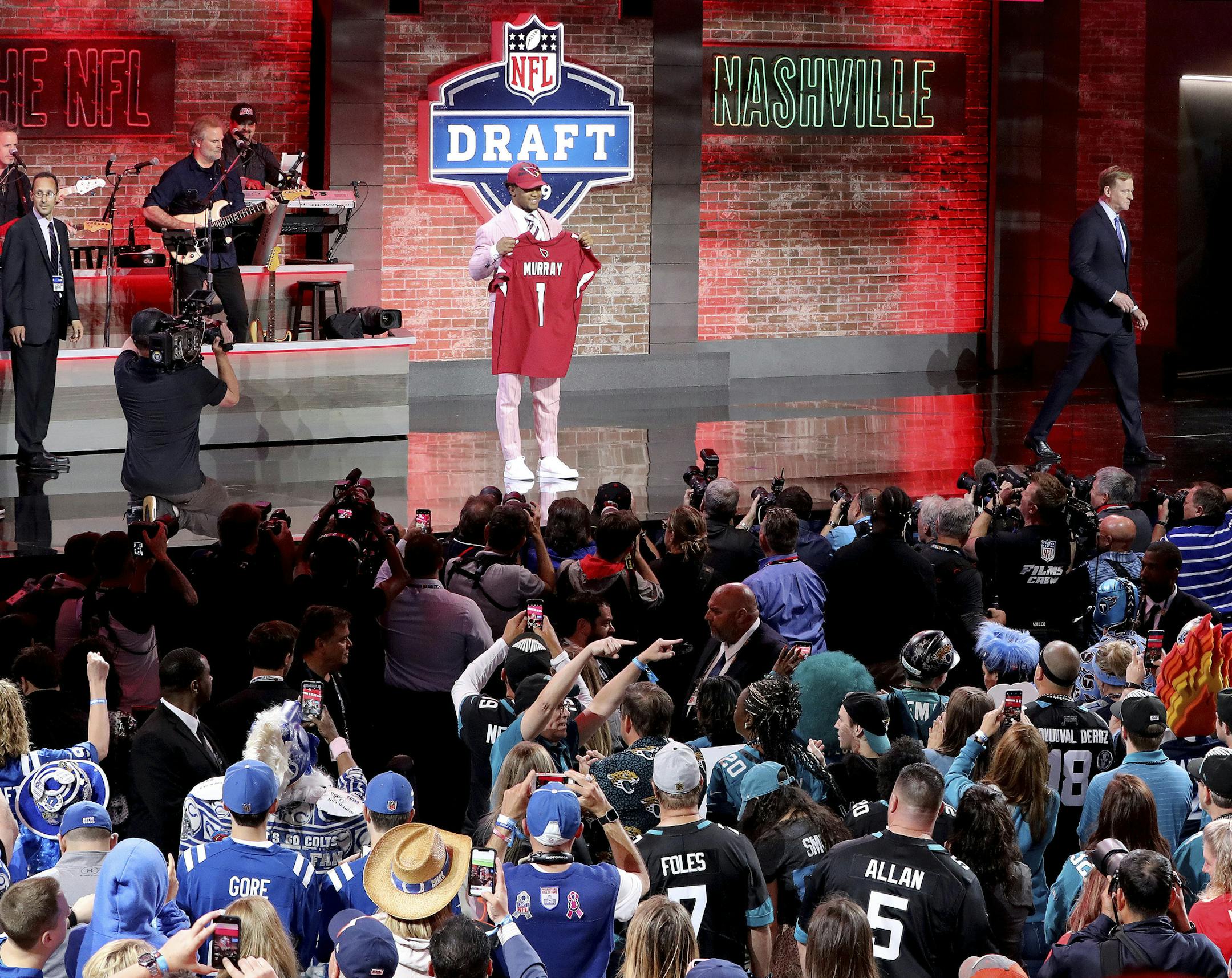 Oklahoma quarterback Kyler Murray shows off his new jersey after the Arizona Cardinals selected Murray in the first round at the NFL football draft, Thursday, April 25, 2019, in Nashville, Tenn. (AP Photo/Gregory Payan)