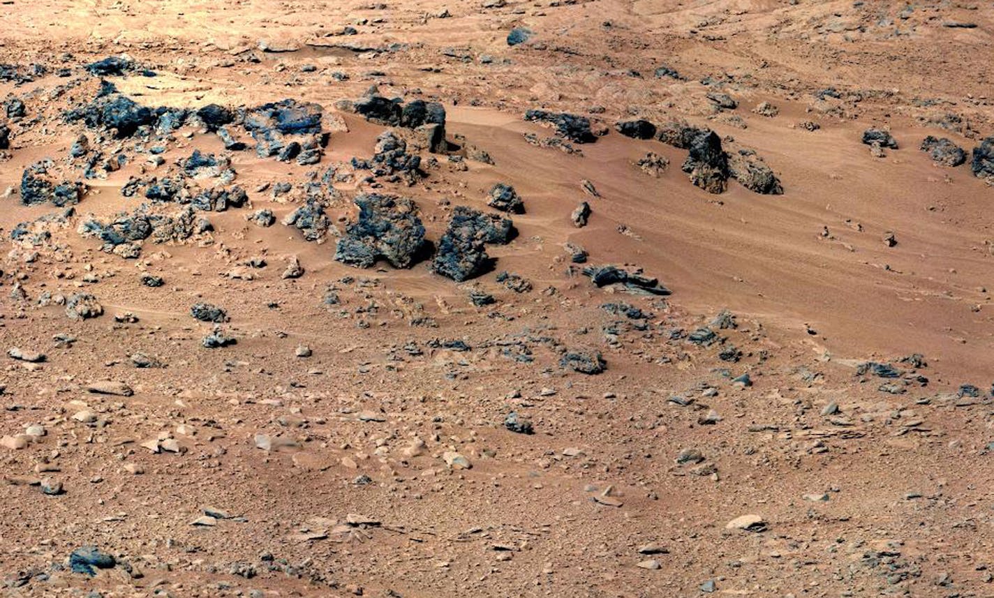 This handout image provided by NASA, taken Sept. 28, 2012, is a mosaic of images taken by the telephoto right-eye camera of the Mast Camera before the rover arrived at Rocknest. Mars Curiosity is about to sip its initial taste of the red planet's sand. But first, NASA's rover has to play bartender to make sure the dry dust is shaken, not stirred.The rover's scoop will dig into the sand Saturday. Then the action starts. Mission sampling chief Daniel Limonadi said the end of the rover's arm will s