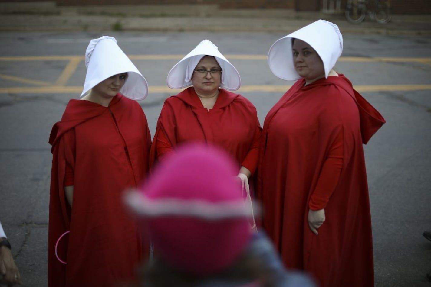 A trio of women dressed as characters from the television series (and book by Margaret Atwood) The Handmaid's Tale, attended the rally at Planned Parenthood of Minnesota's headquarters Wednesday night. They are, from left, Rachel Cleveland, Chris Pederson, and Marie Porter, who made the costumes.