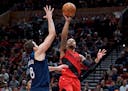 Portland Trail Blazers guard Damian Lillard shoots over Minnesota Timberwolves forward Nemanja Bjelica during the second half of an NBA basketball gam