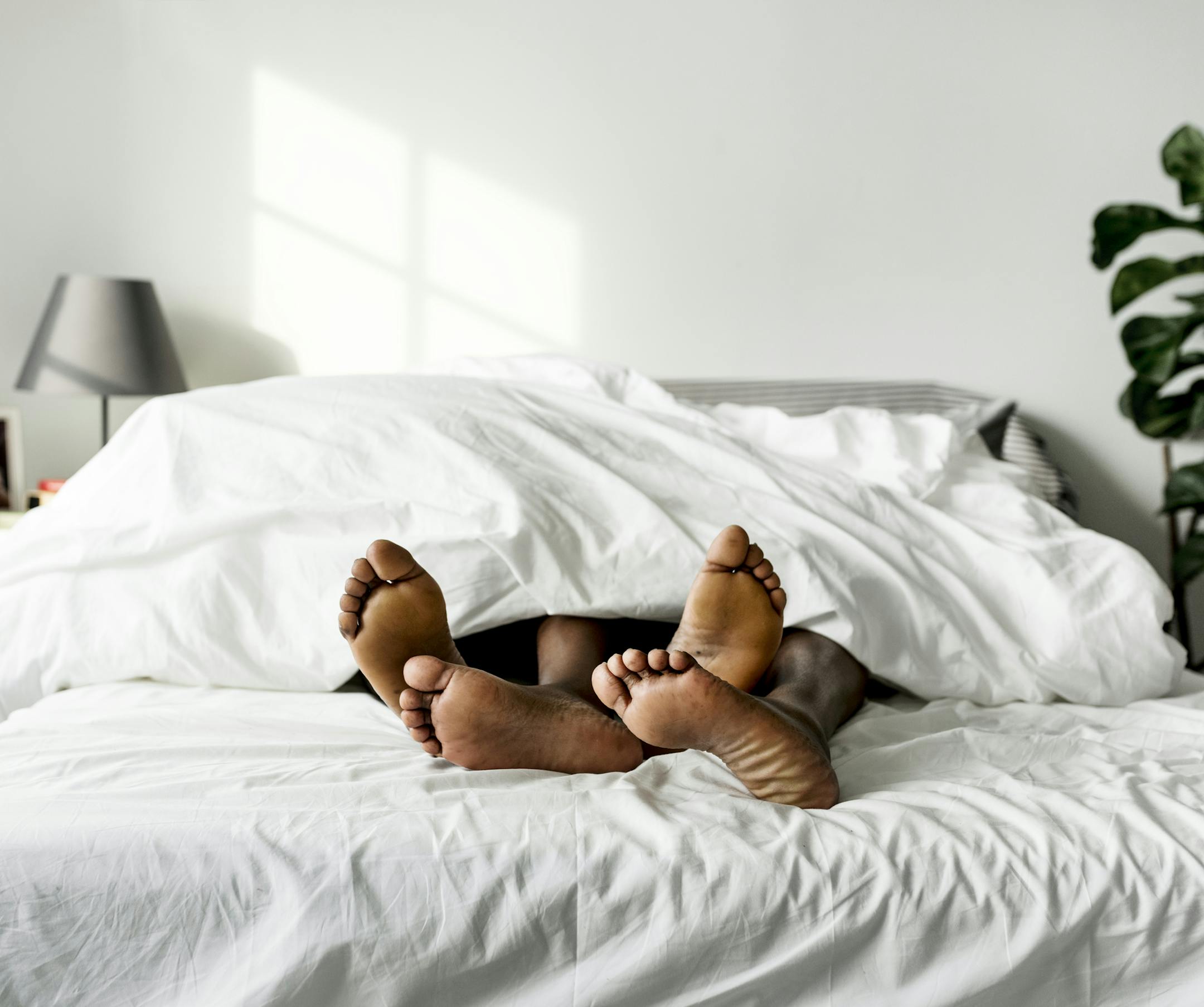 Black couple lying on bed together sex concept