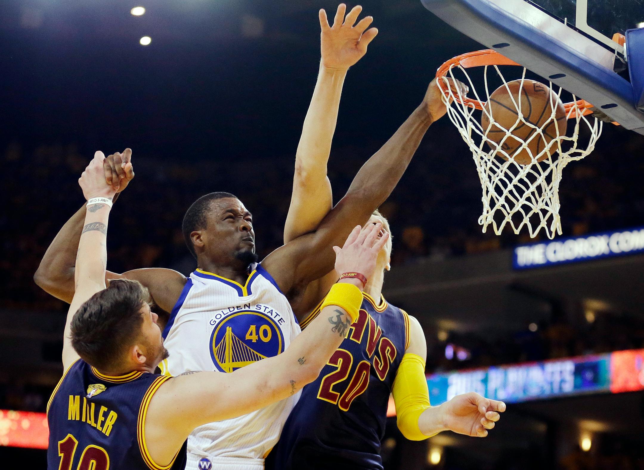 Warriors forward Harrison Barnes dunked over Cavaliers guard Mike Miller, left, and center Timofey Mozgov during the second half of Game 5 of the NBA Finals on Sunday.