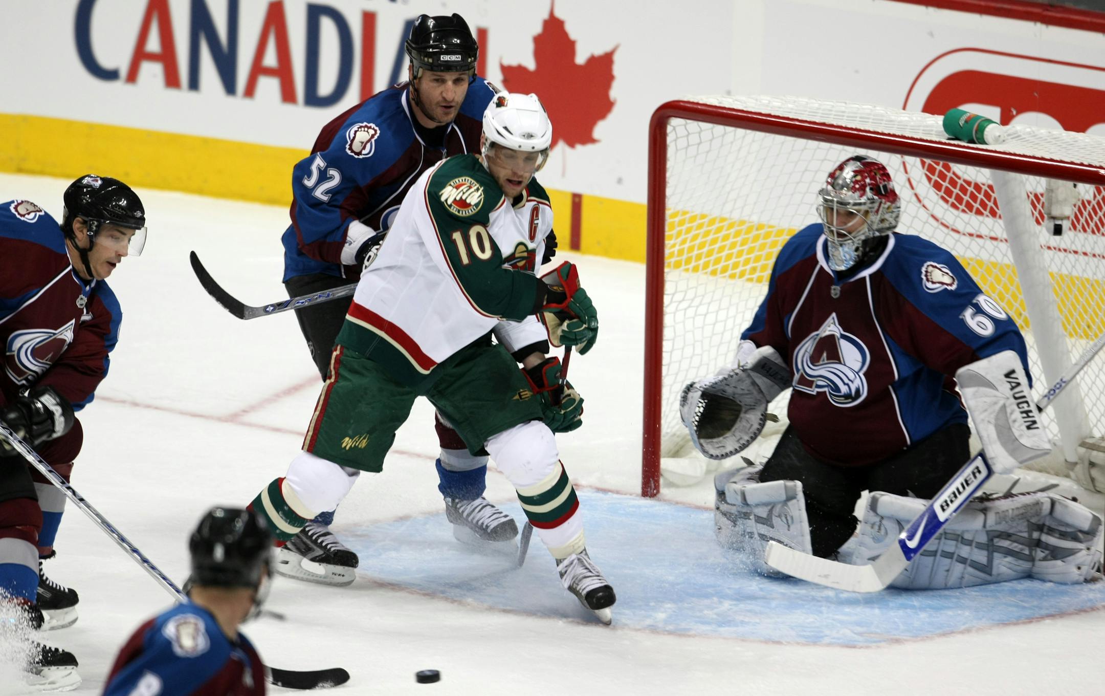 Marian Gaborik #10 of the Minnesota Wild tries to control the puck in front of goalie Jose Theodore #60 of the Colorado Avalanche as Adam Foote #52 of the Avs skates in during the first period of game six of the first round NHL playoff series on saturday april 19, 2008 in Denver, CO. Minnesota vs. Colorado, game 6, Stanley Cup Playoffs.