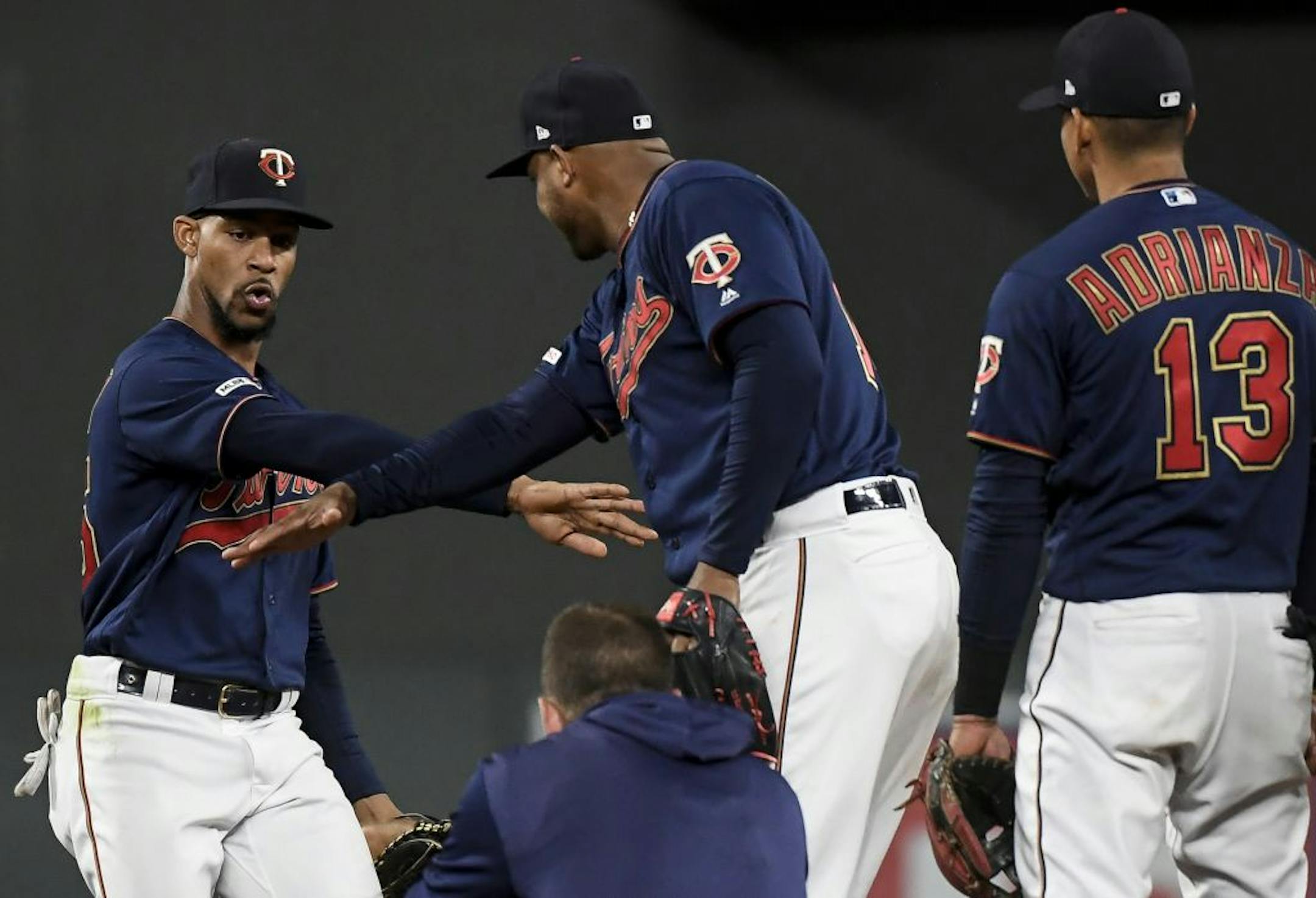 Minnesota Twins center fielder Byron Buxton (25) celebrated with teammates, including second baseman Jonathan Schoop (16), after their 8-3 victory against the Detroit Tigers.