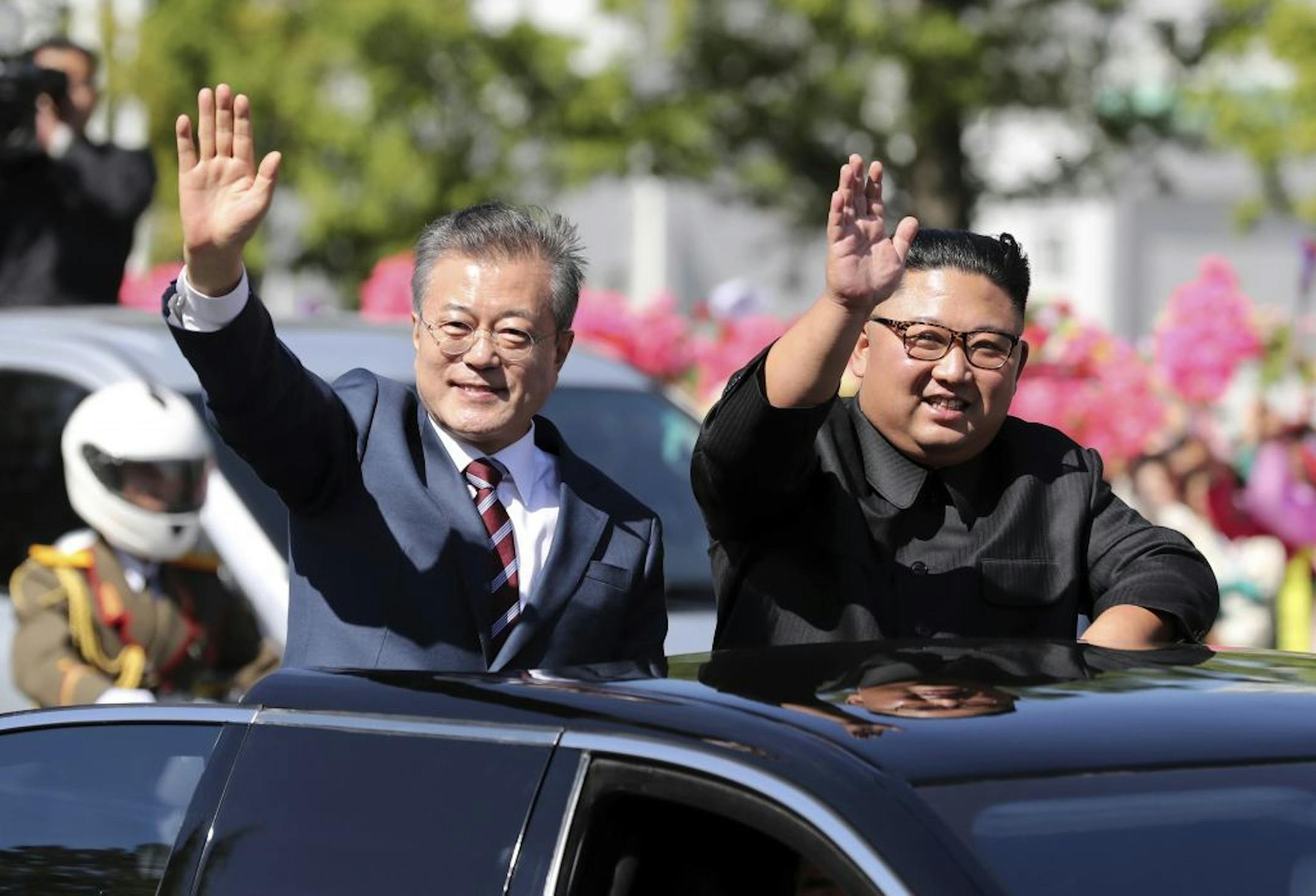 In this Tuesday, Sept. 18, 2018, file photo, South Korean President Moon Jae-in, left, and North Korean leader Kim Jong-un ride in a car during a parade through a street in Pyongyang, North Korea.