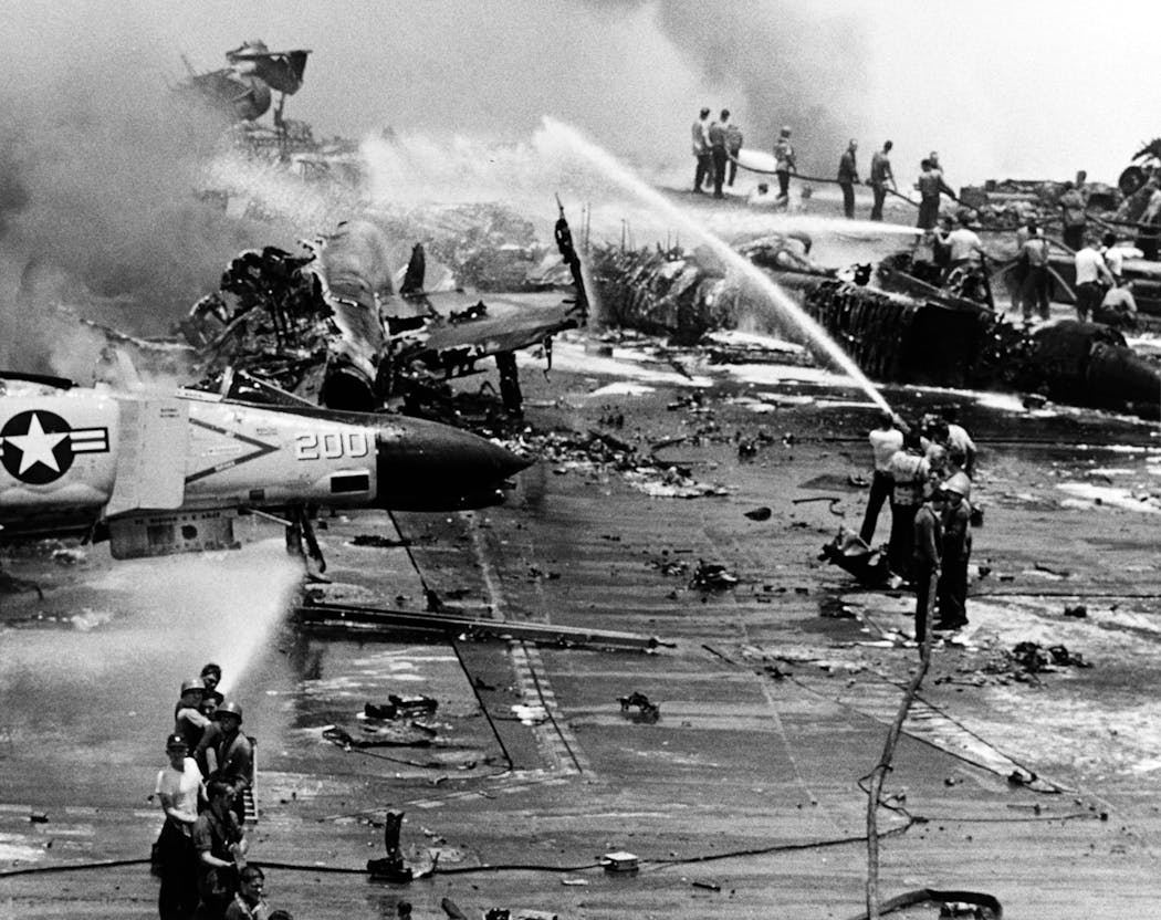 Crew members fought a series of fires and explosions on the carrier’s after flight deck, in the Gulf of Tonkin, on July 29, 1967.
