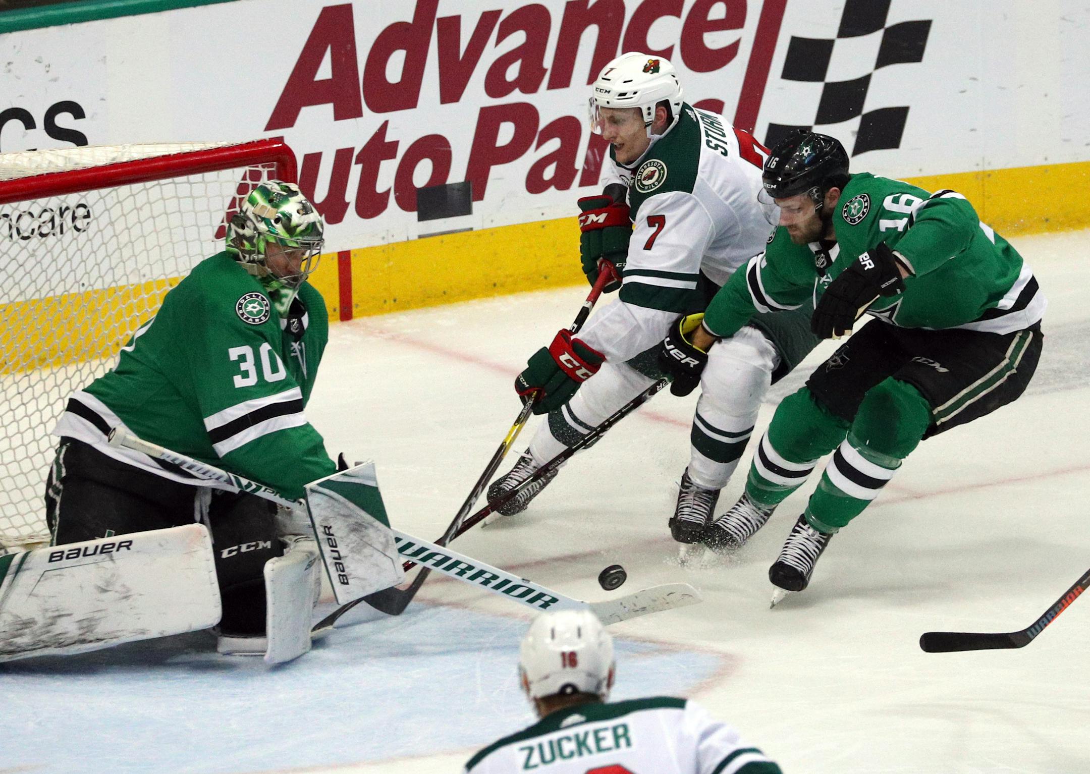 Dallas goaltender Ben Bishop and center Jason Dickinson defend as Wild center Nico Sturm shoots in the second period