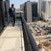 Nick Murnane, real estate manager for Opus Development Co., is standing on the balcony at the new Nic on Fifth apartments where he has a view an apart