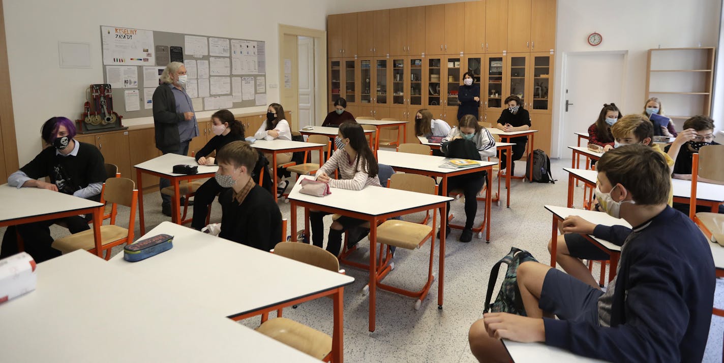 9th grade students listen to instructions at an elementary school in Prague, Czech Republic, Monday, May 11, 2020. At elementary schools, those students who are preparing for an entrance exam at high schools can return to schools in voluntary classes no bigger than 15 as the Czech Republic is taking a step to normalcy amid the coronavirus pandemic by easing more restrictions adopted by the government to contain it. (AP Photo/Petr David Josek)