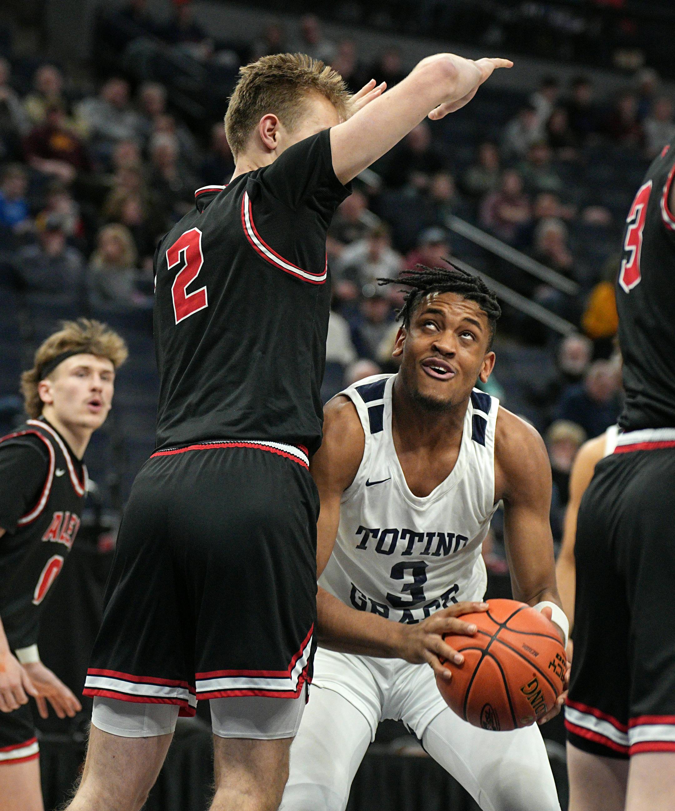 Totino-Grace's Tommy Humphries tried to find air under the arms of Alexandria's Grayson Grove in the second half.