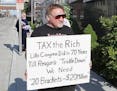 In this undated file photo, James Hodgkinson holds a sign during a protest outside of a United States Post Office in Belleville, Ill. Hodgkinson has b