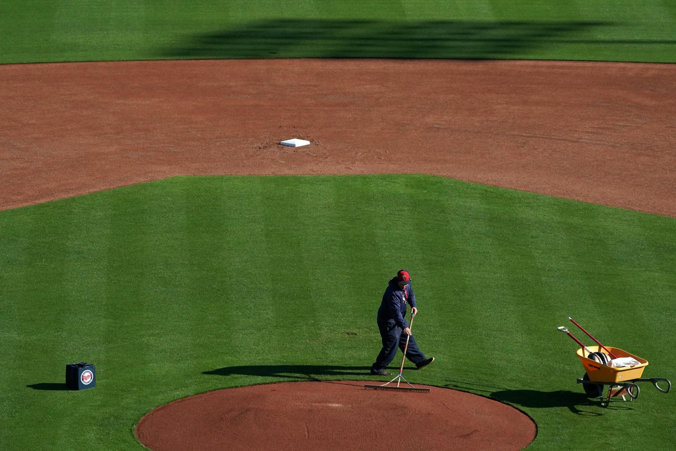 A member of the grounds crew readied the pitcher's mound at Hammond Stadium for the first official Twins workout of Spring Training Thursday morning.