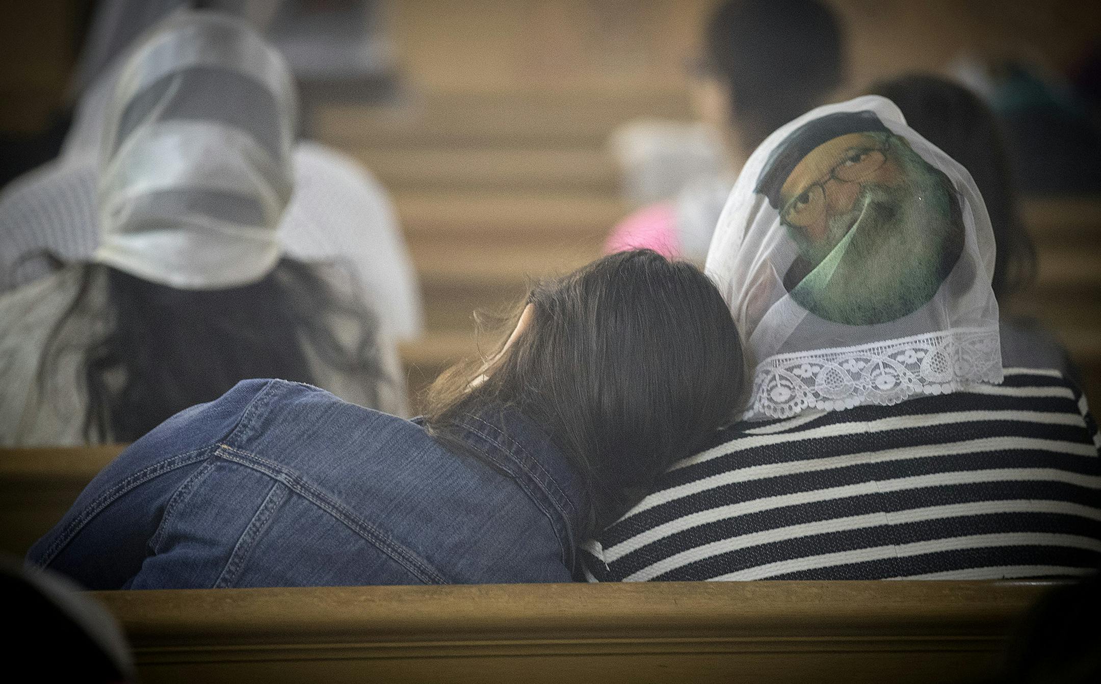 Members of the St. Mary's Coptic Orthodox Church traditional wear head scarfs with images of different saints and Jesus and Mary, during a mass, Sunday, April 30, 2017 in South St. Paul, MN. ] ELIZABETH FLORES &#xef; liz.flores@startribune.com